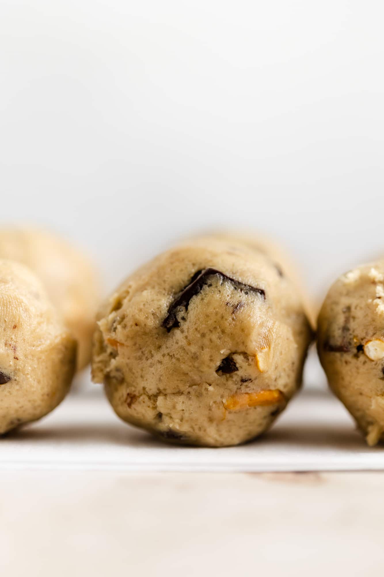 close up on small balls of kitchen sink cookie dough.