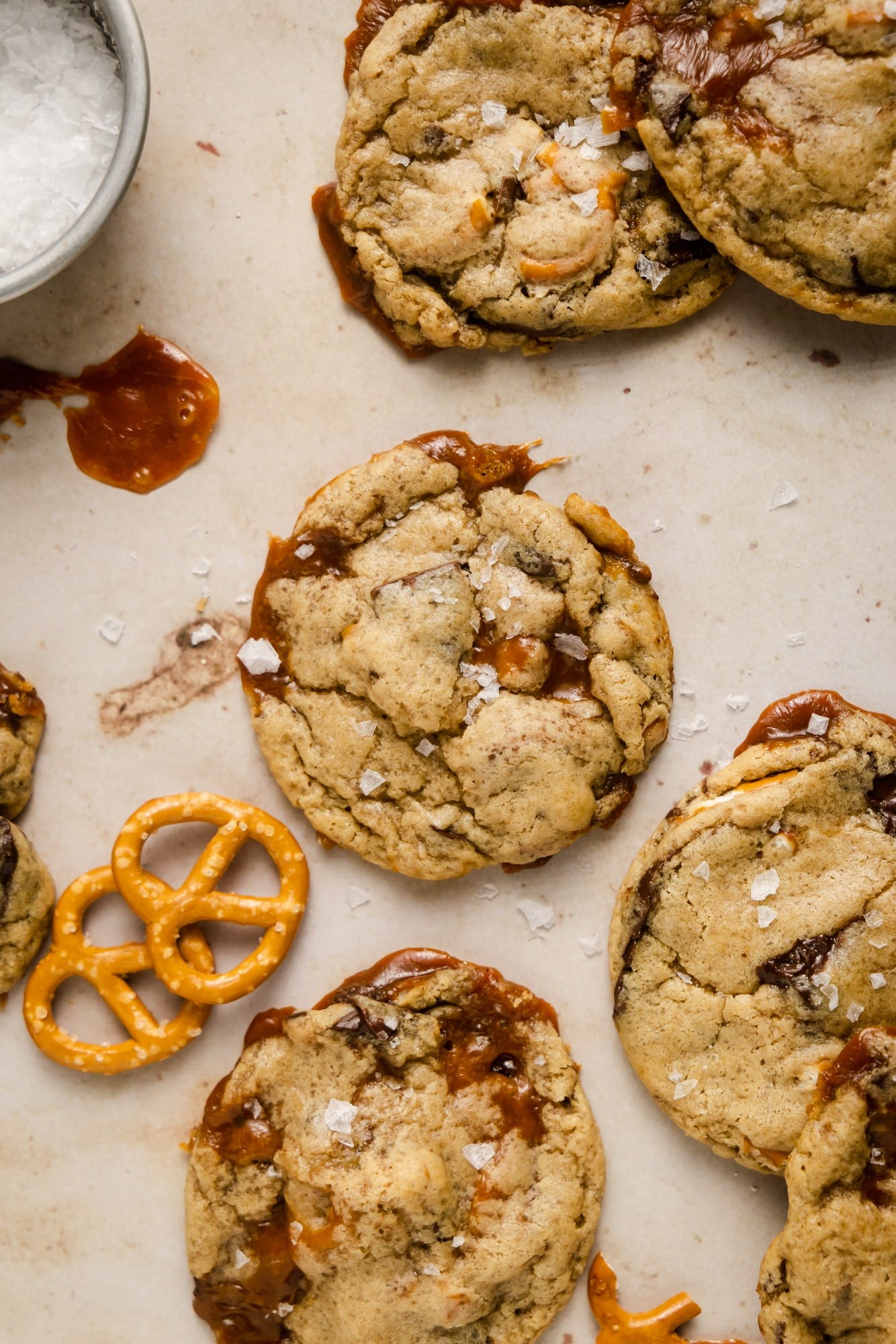 baked kitchen sink cookies next to a small bowl of flake salt and pretzels.