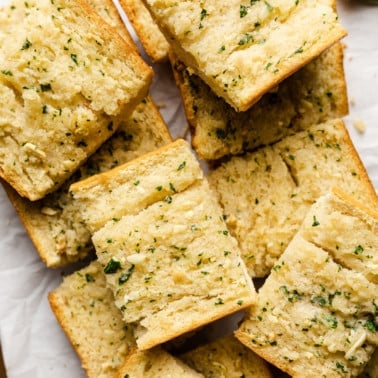 slices of vegan garlic bread piled on top of each other.