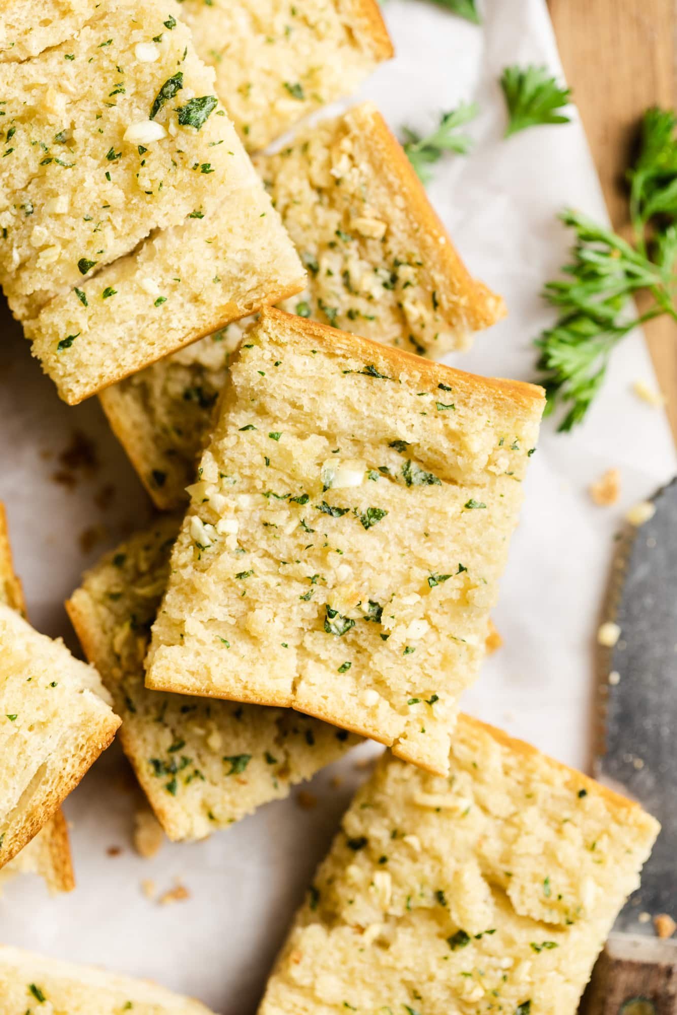 close up on pieces of baked vegan garlic bread on top of each other.