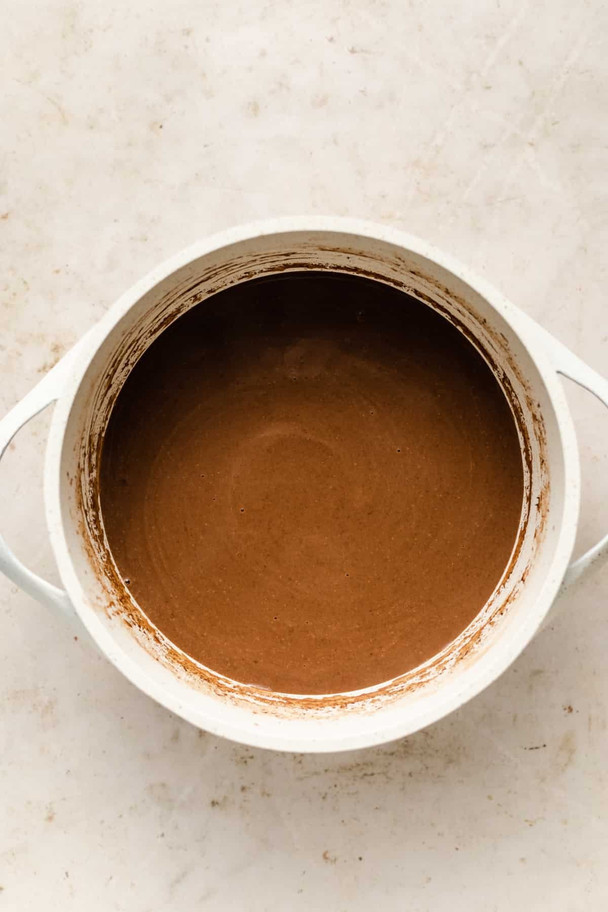 vegan hot chocolate in a white saucepan.