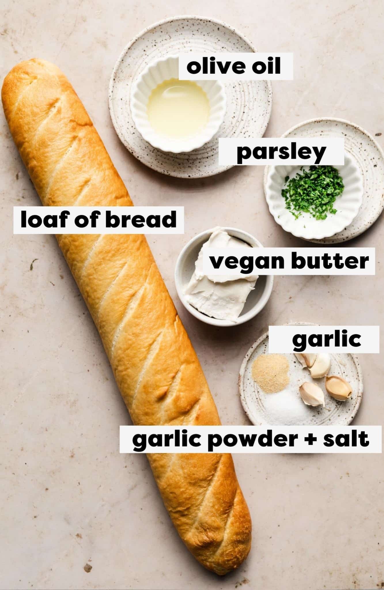 ingredients with labels for vegan garlic bread in small white bowls.