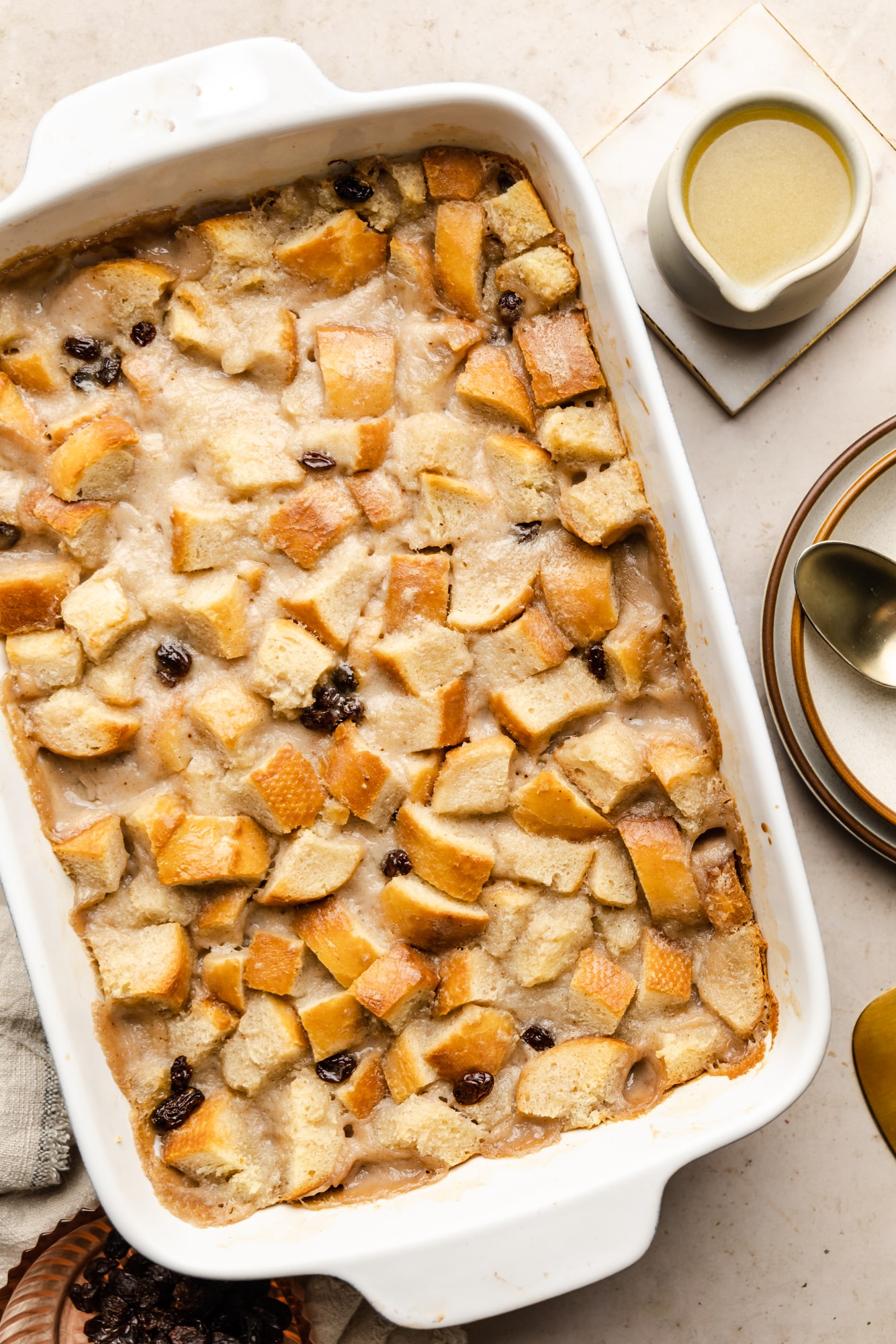 baked vegan bread pudding in a white baking dish.