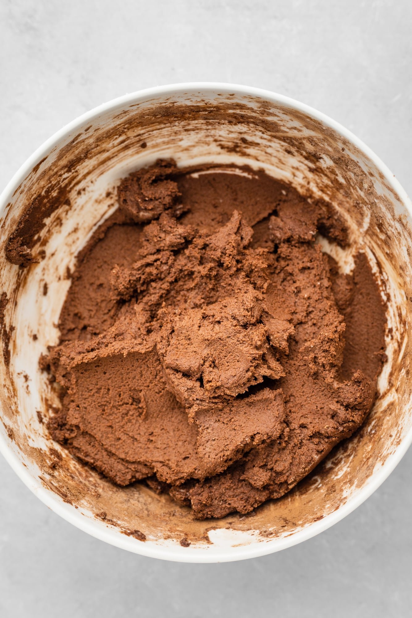 Vegan chocolate sugar cookie dough in a large white bowl.