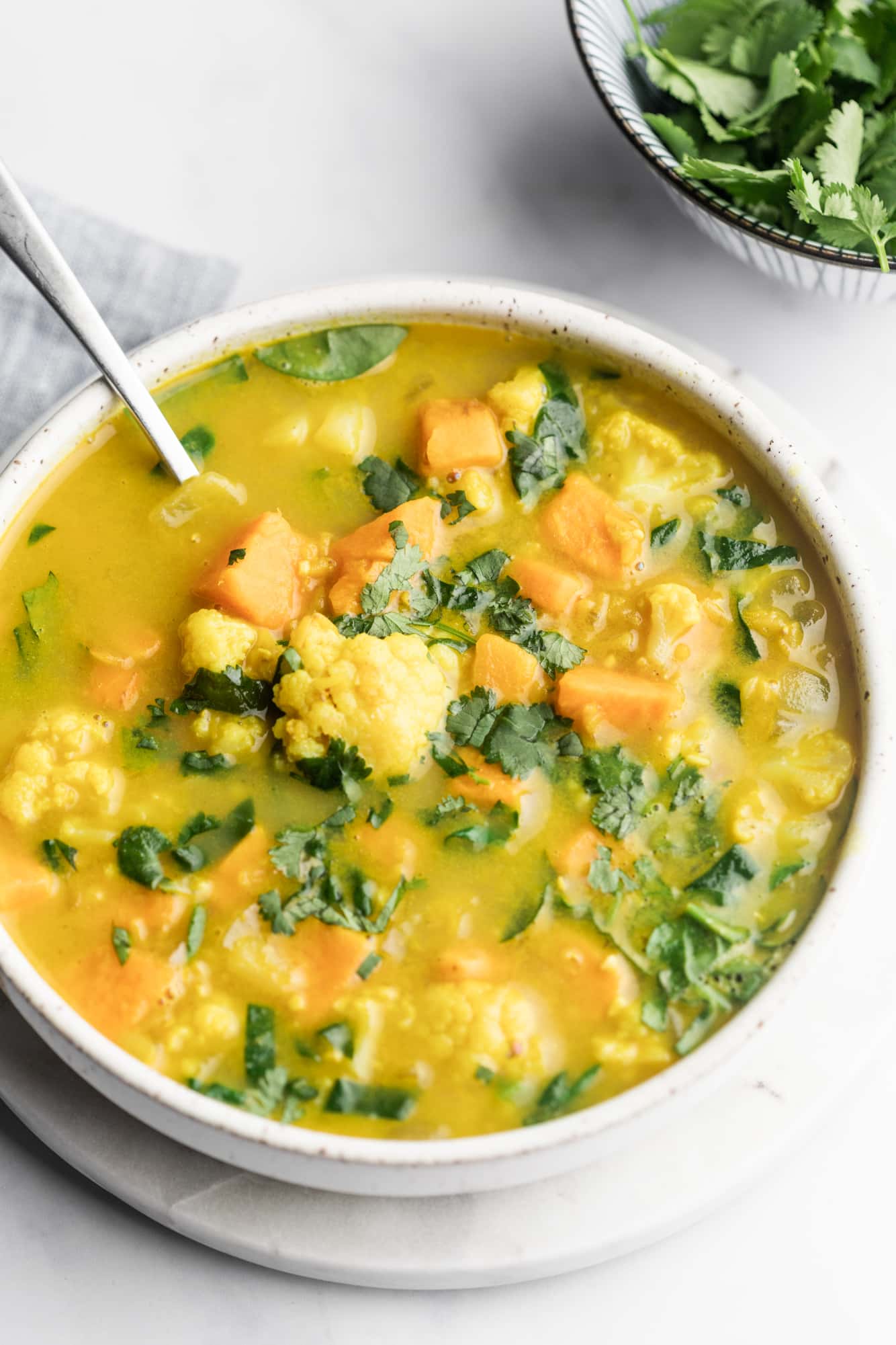 coconut curry lentil soup in a large white bowl.