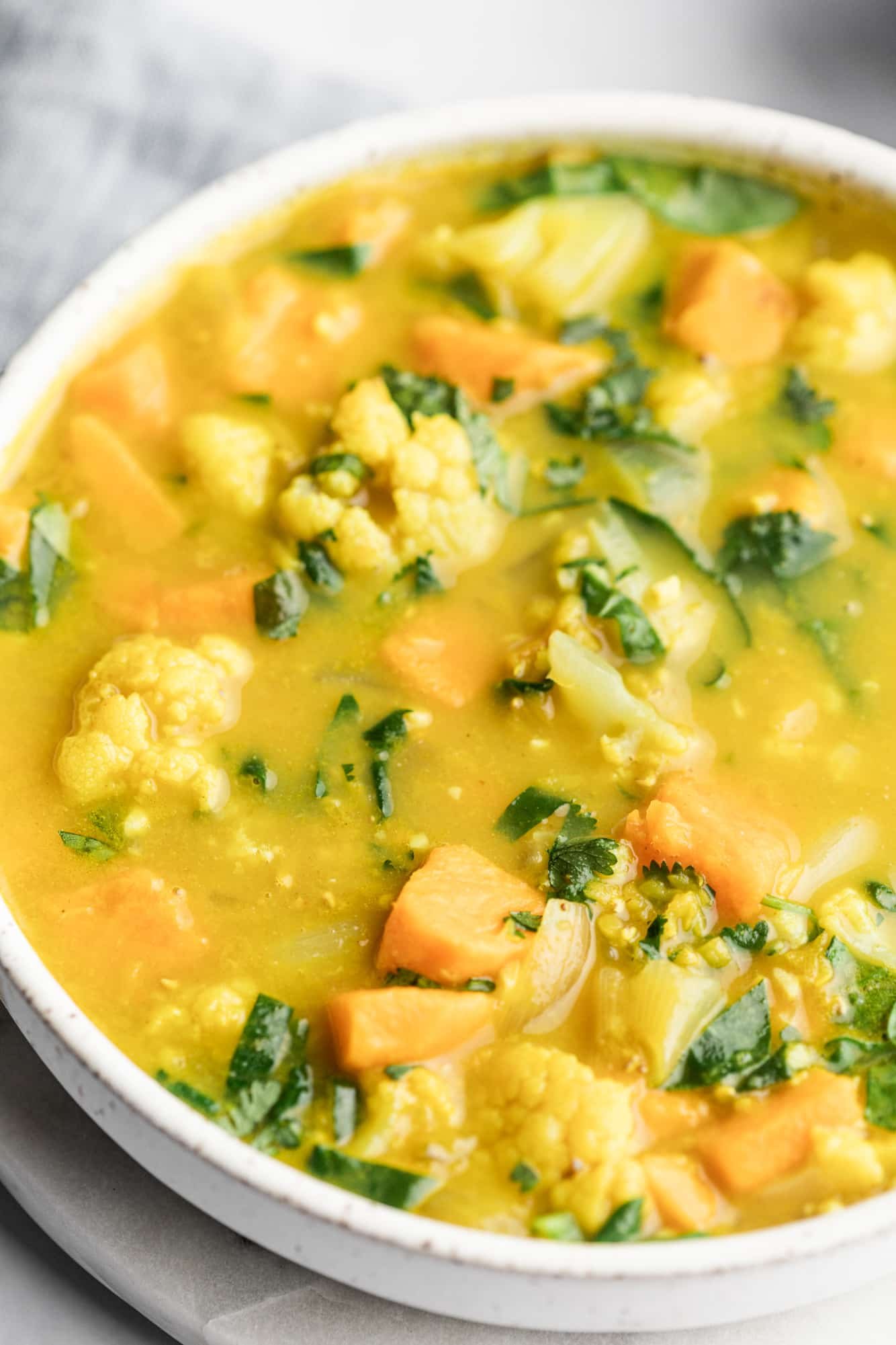 coconut curry lentil soup in a large white bowl.