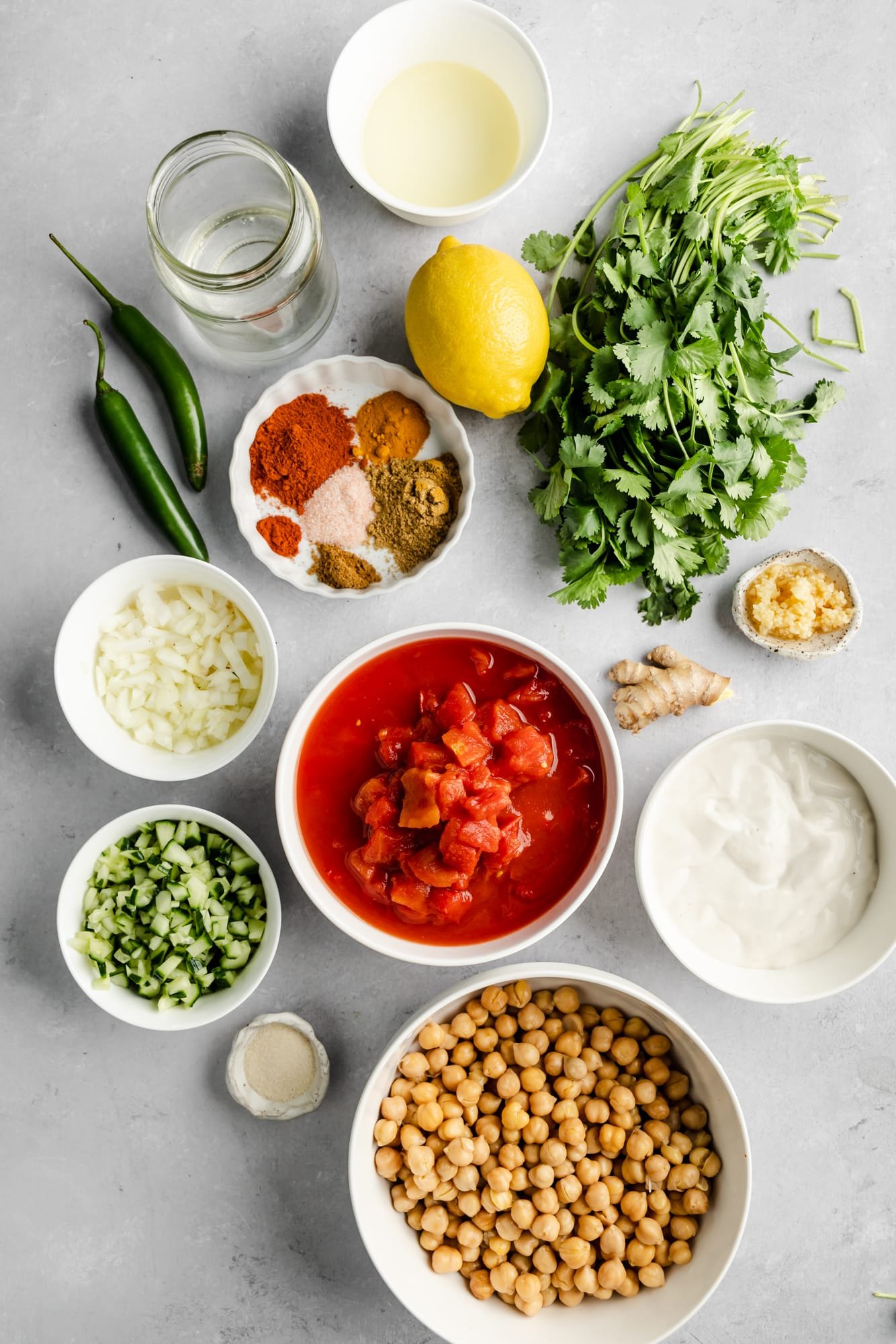 ingredients for easy chana masala in individual white bowls.