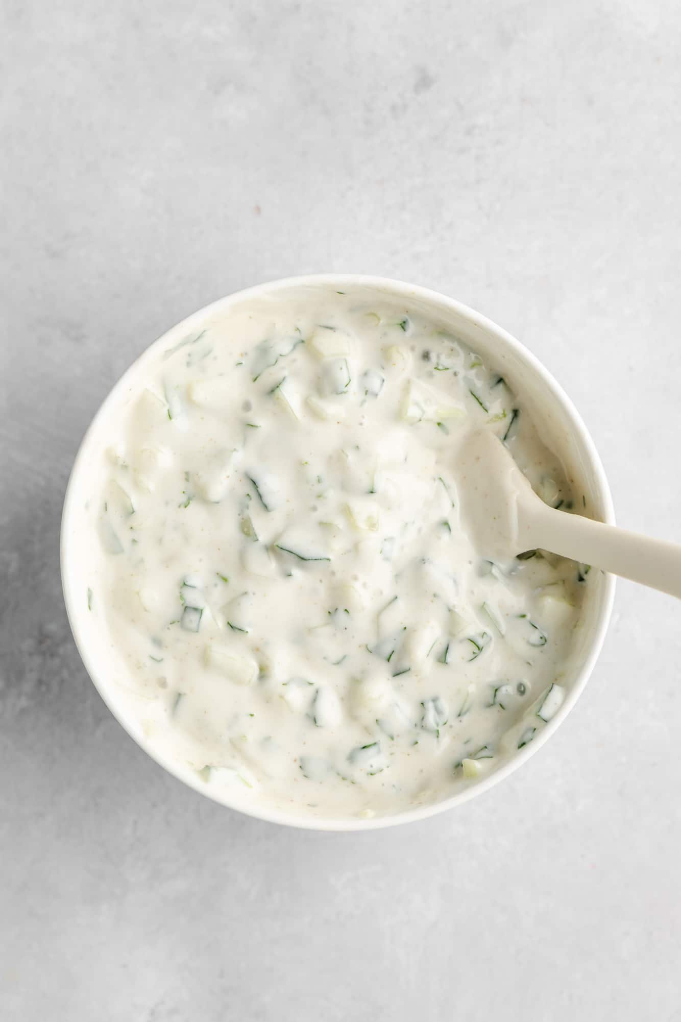 a creamy vegan yogurt sauce in a white bowl.