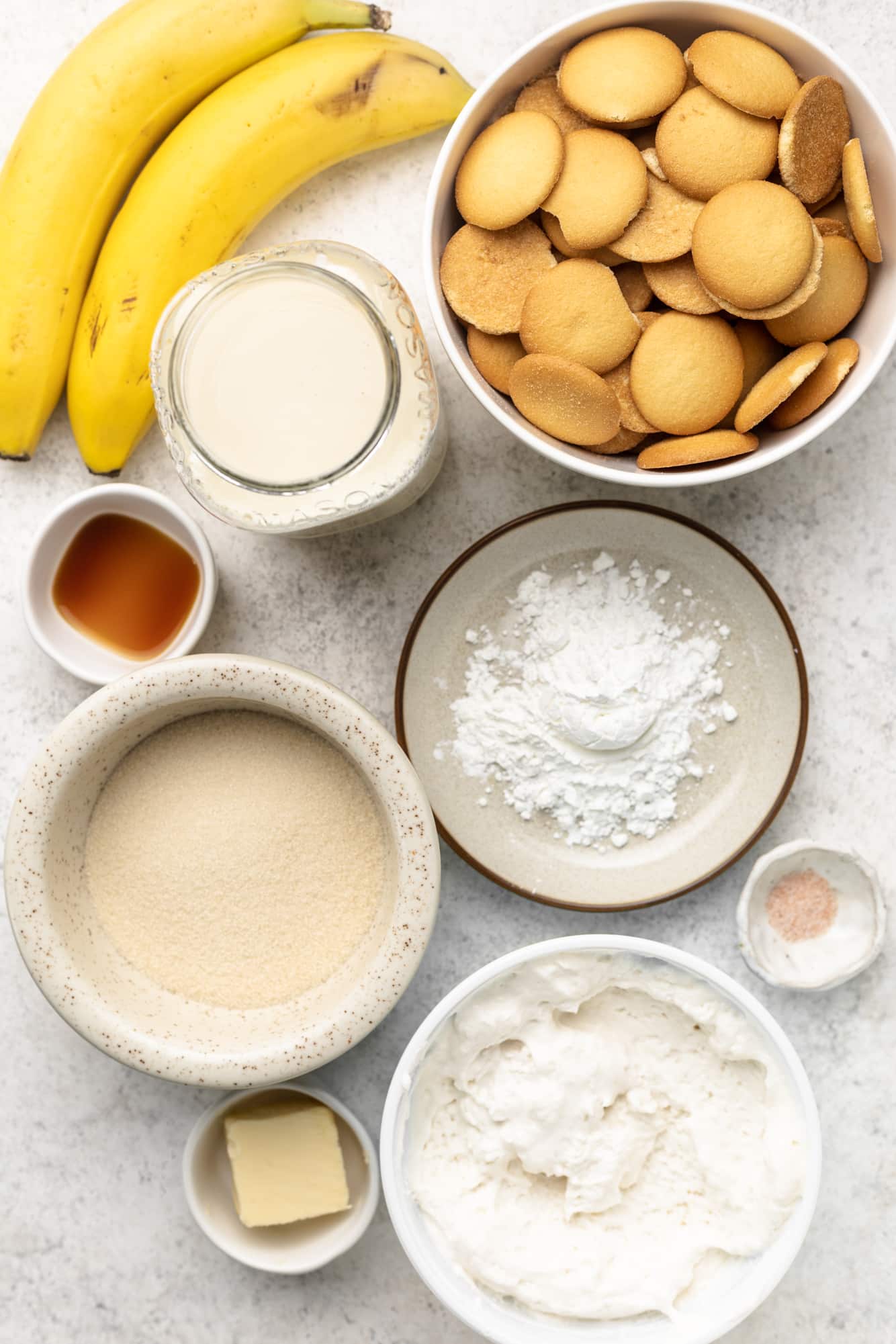 ingredients for vegan banana pudding in individual white bowls.