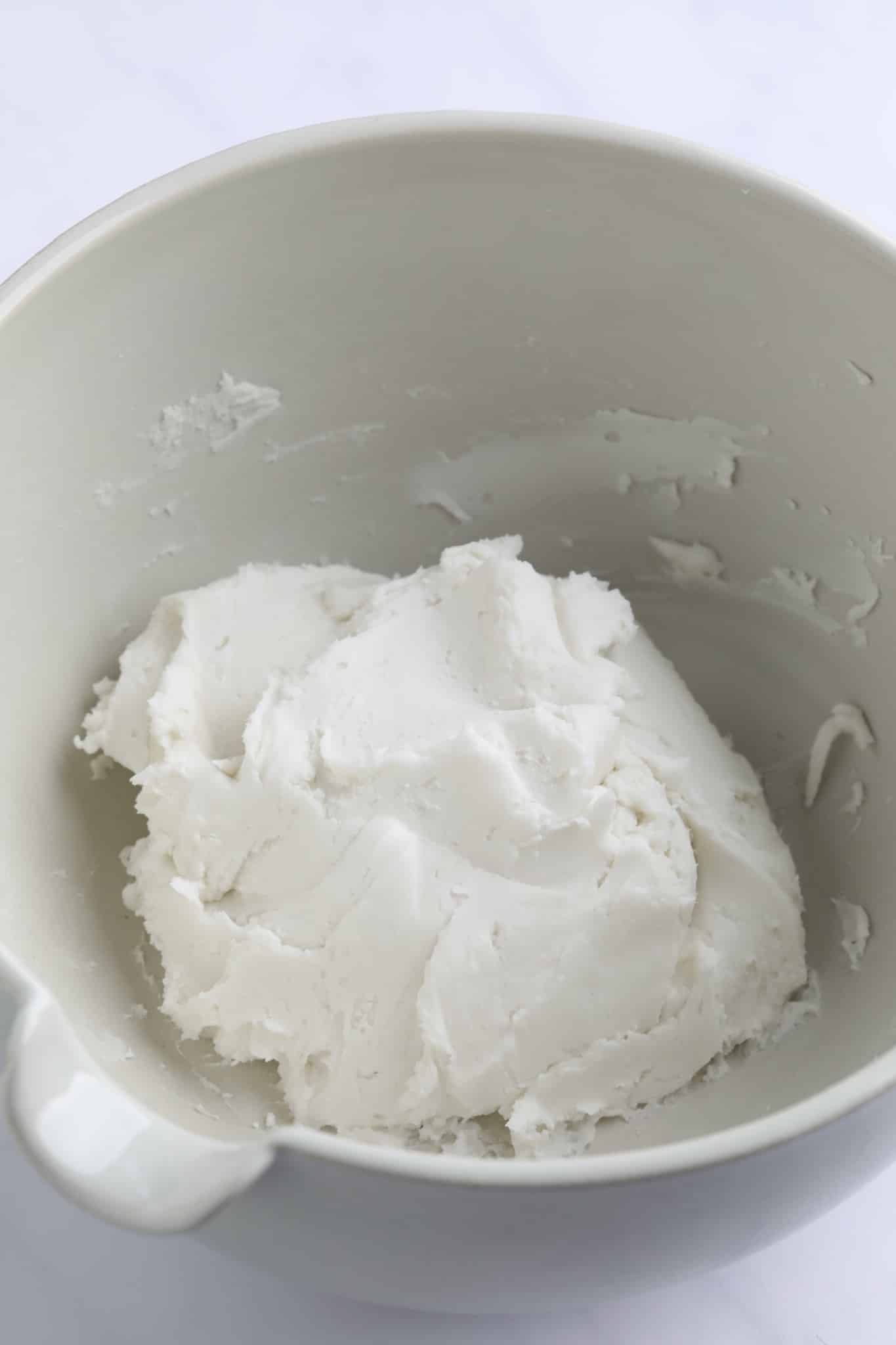 a ball of white dough in a large white bowl.