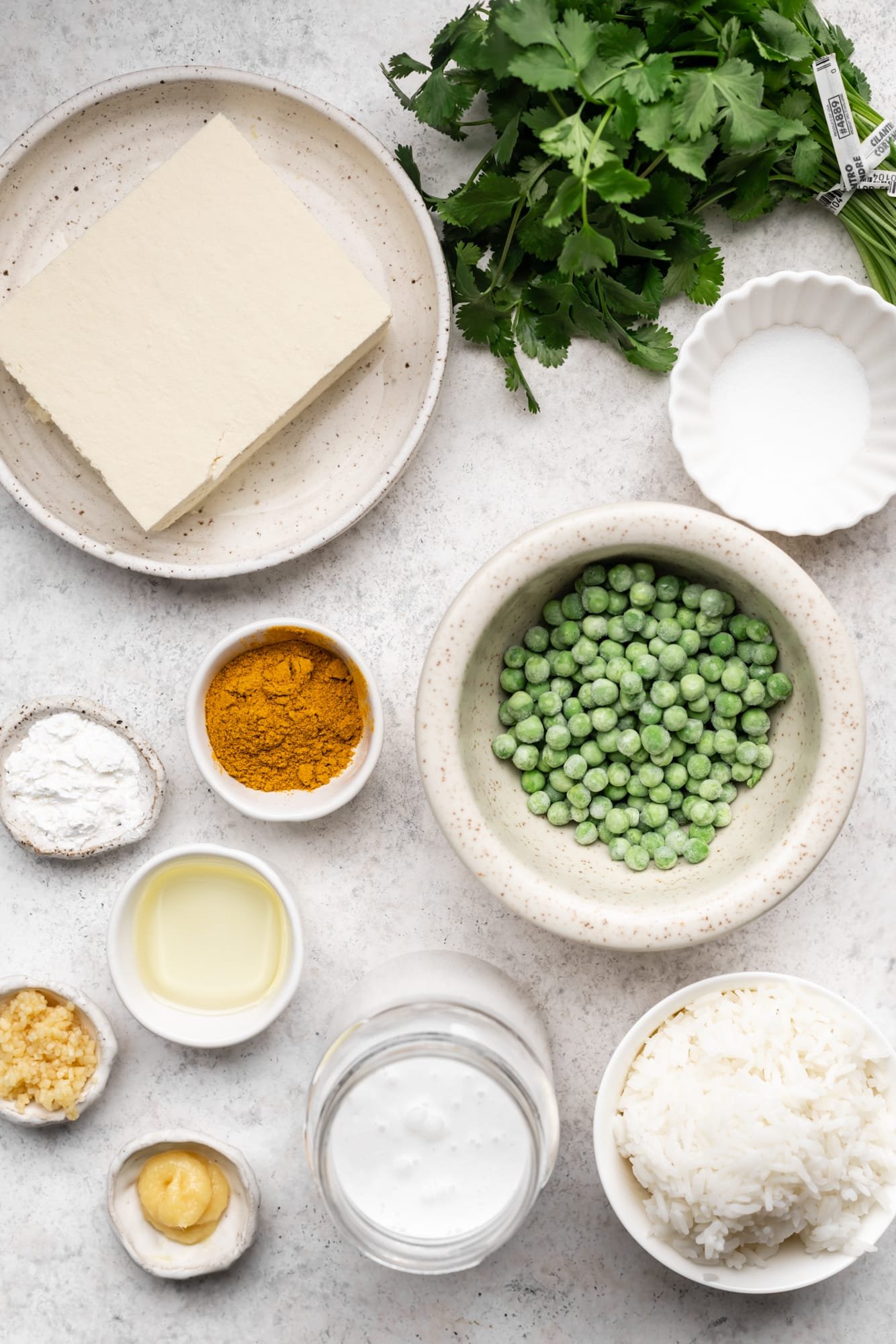 ingredients for tofu curry in individual white bowls.