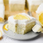 a piece of vegan lemon poppyseed cake on a small grey plate.