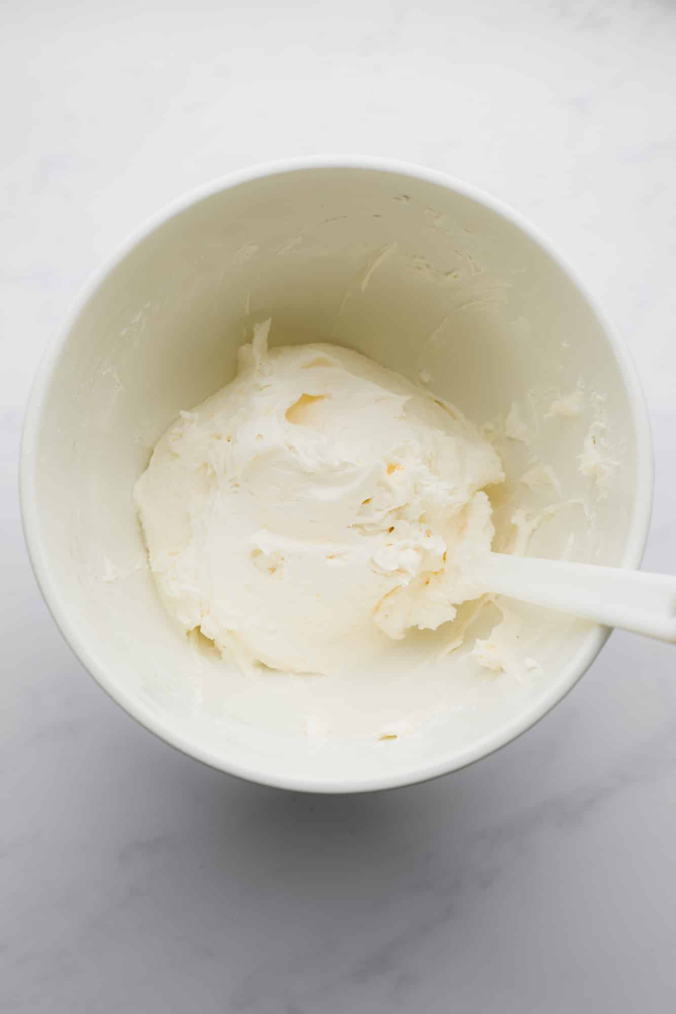 white buttercream frosting in a large white bowl.