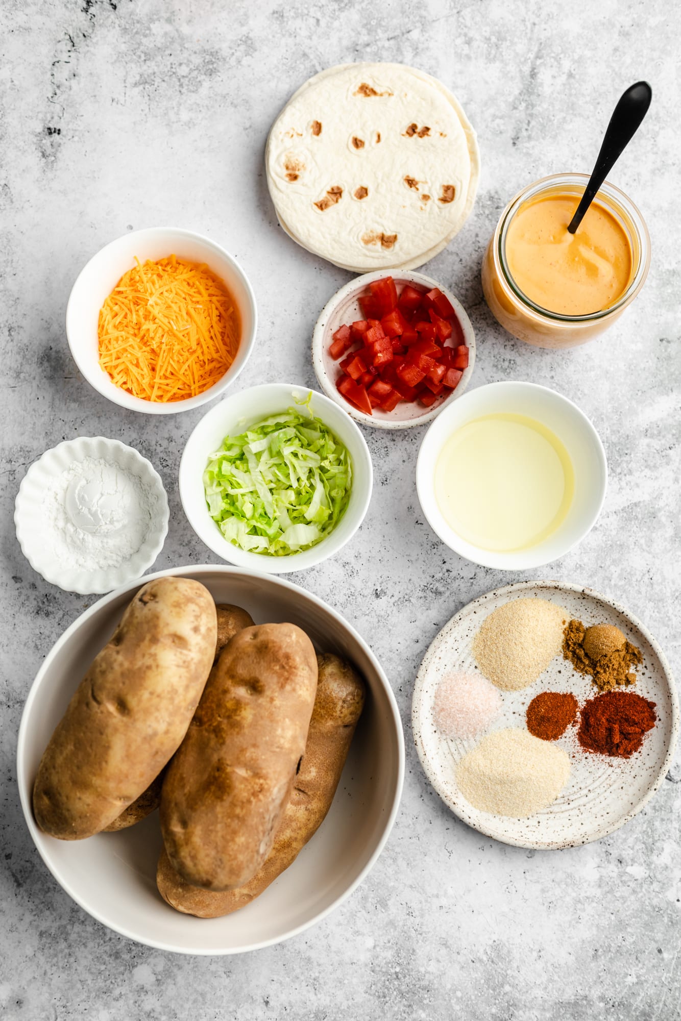 ingredients for vegan potato tacos in individual white bowls.