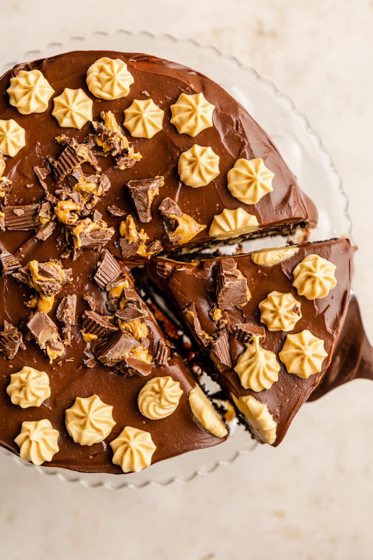 lifting a slice of chocolate peanut butter cake from the whole cake.