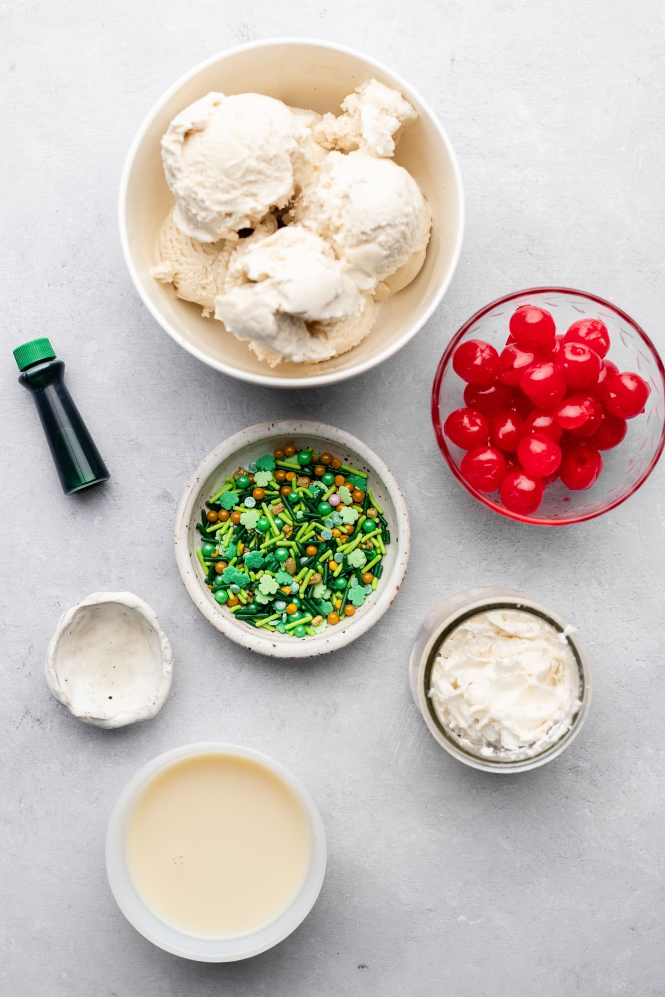 ingredients for a vegan shamrock shake in individual white bowls.