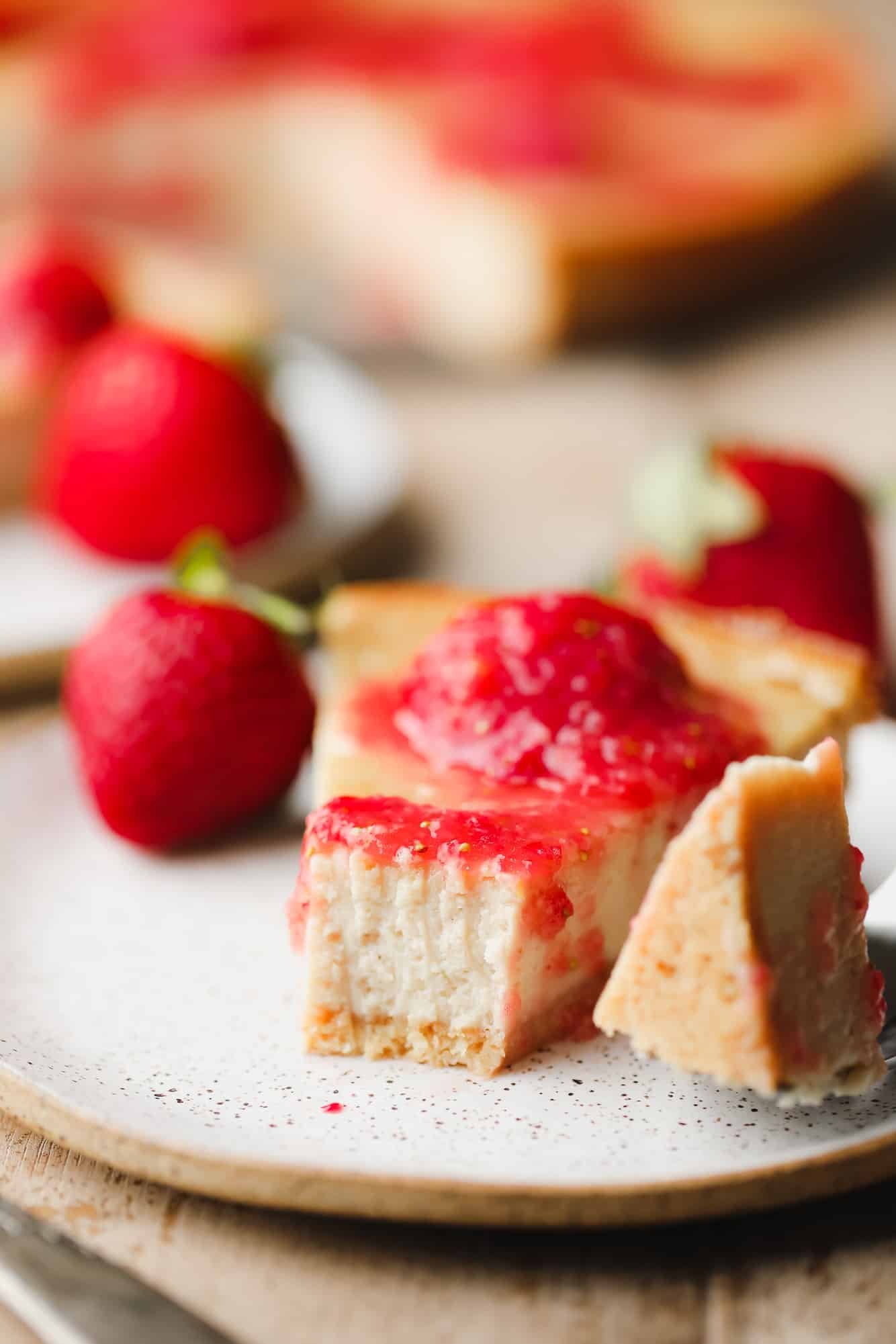 close up on a slice of cashew cheesecake with a bite missing.