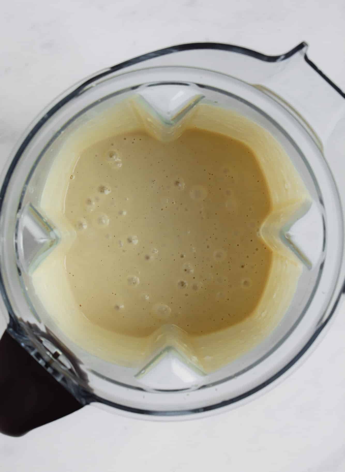 a creamy white cashew sauce in a blender.