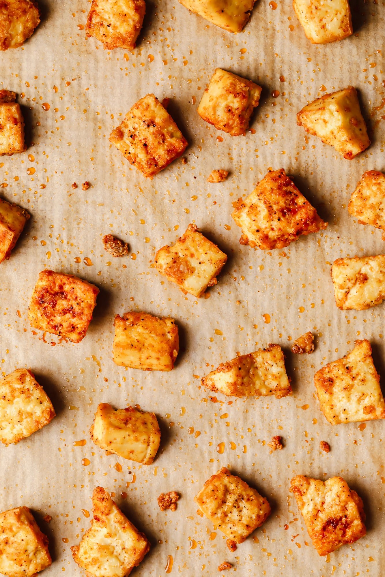 close up on baked tofu pieces on a baking sheet.