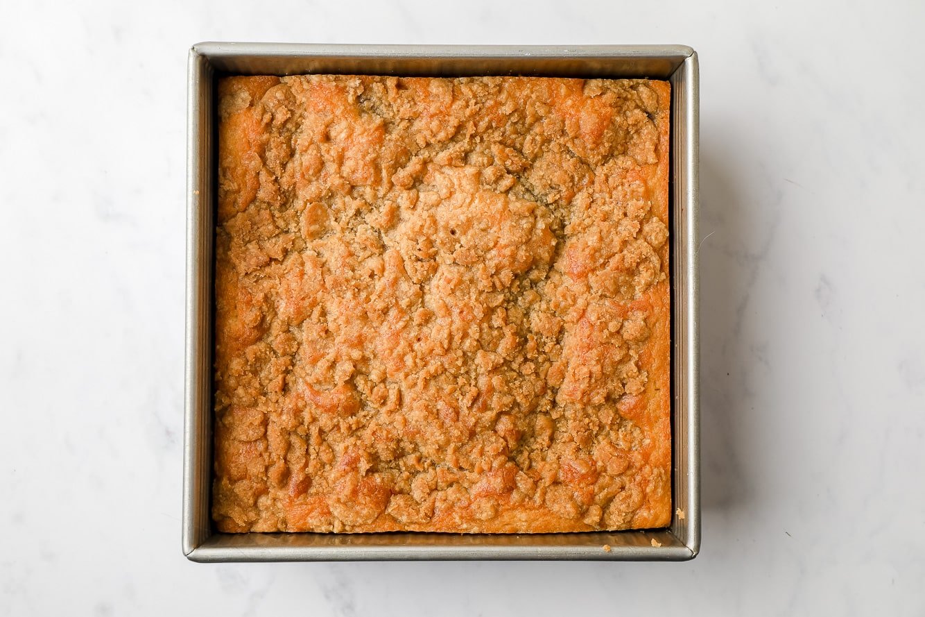 baked blueberry coffee cake in a square baking pan.