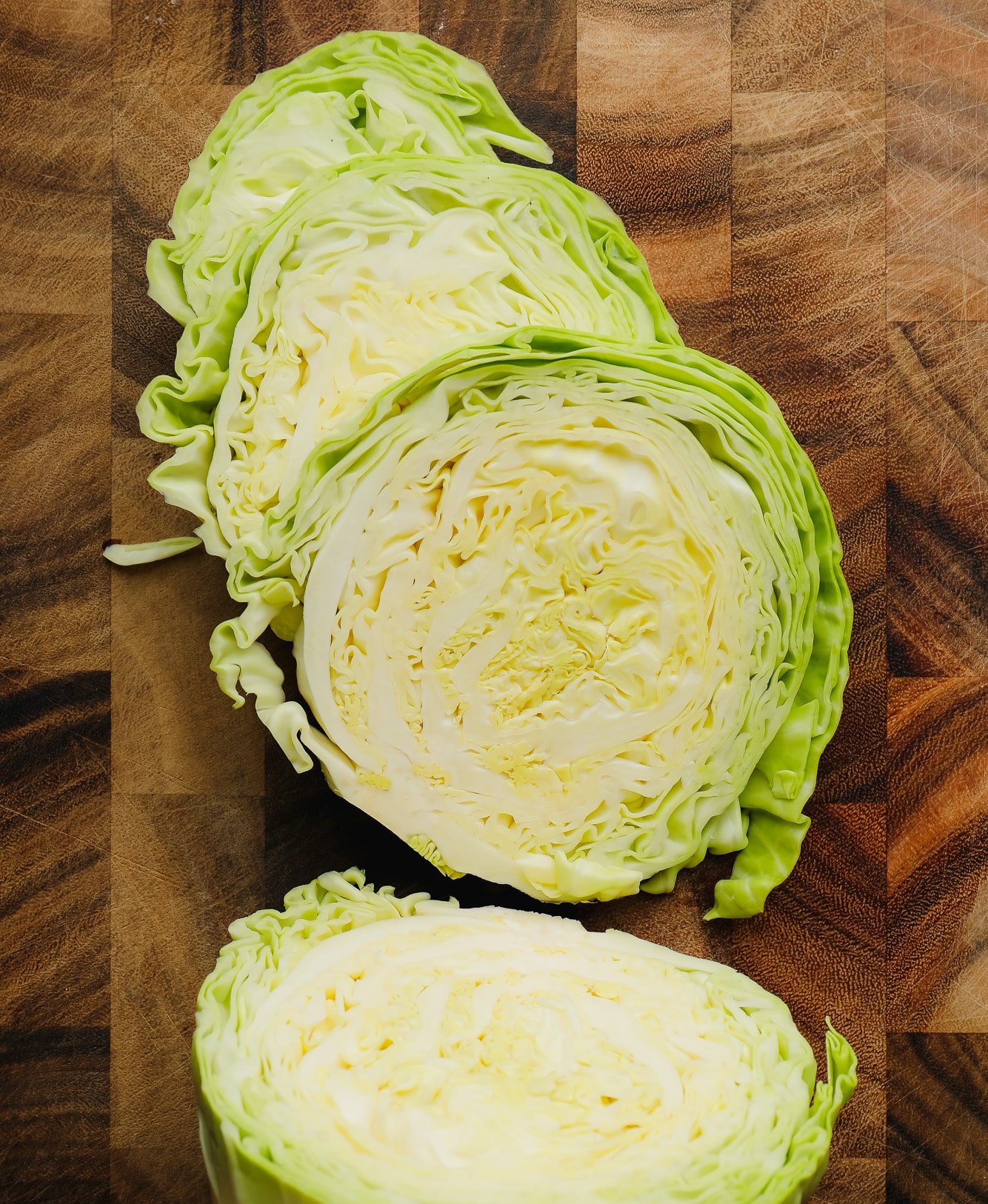 raw green cabbage cut into large slices.