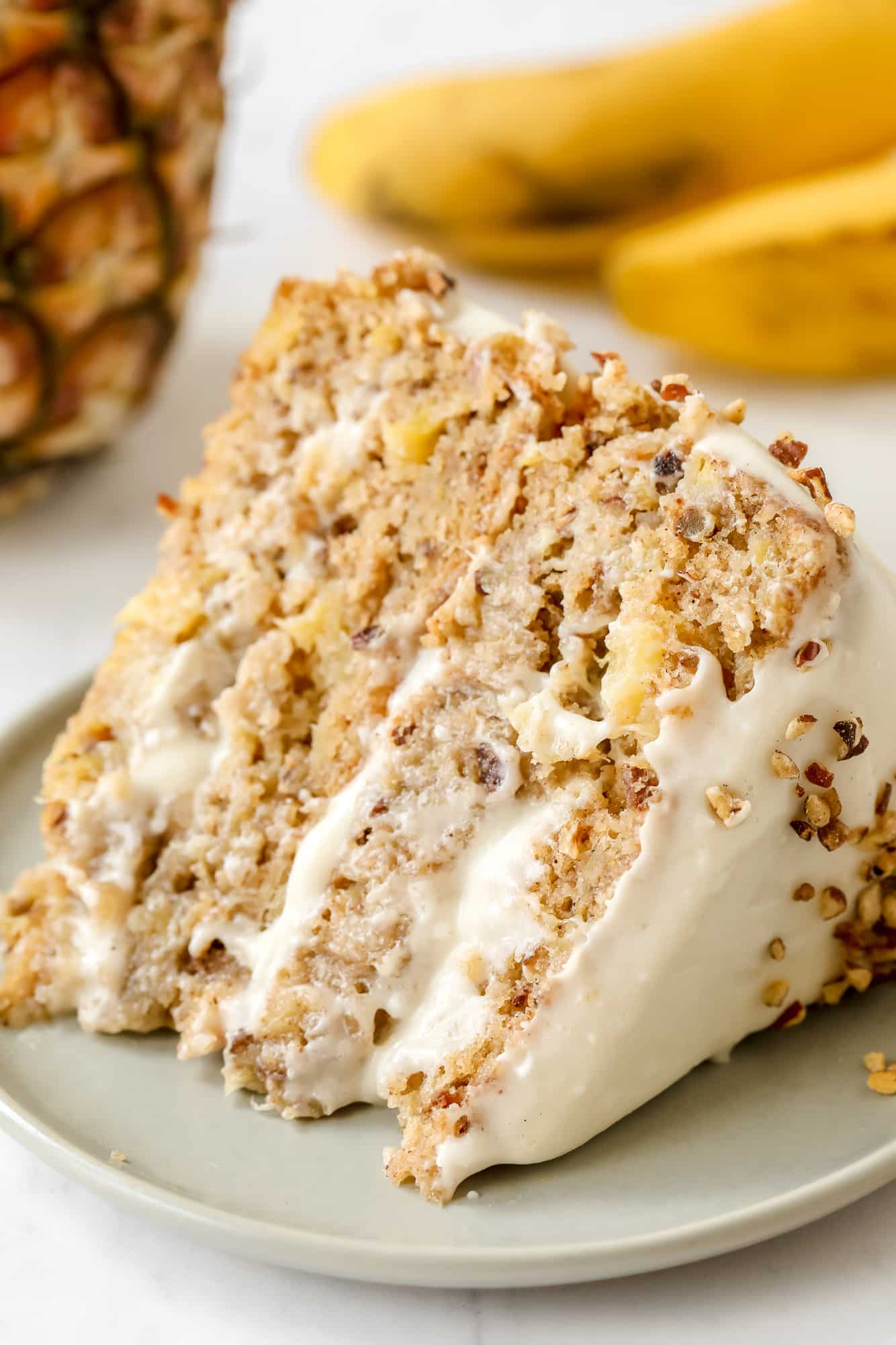 a slice of vegan hummingbird cake on a grey plate.