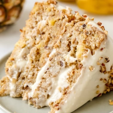 close up on a slice of vegan hummingbird cake on a grey plate.