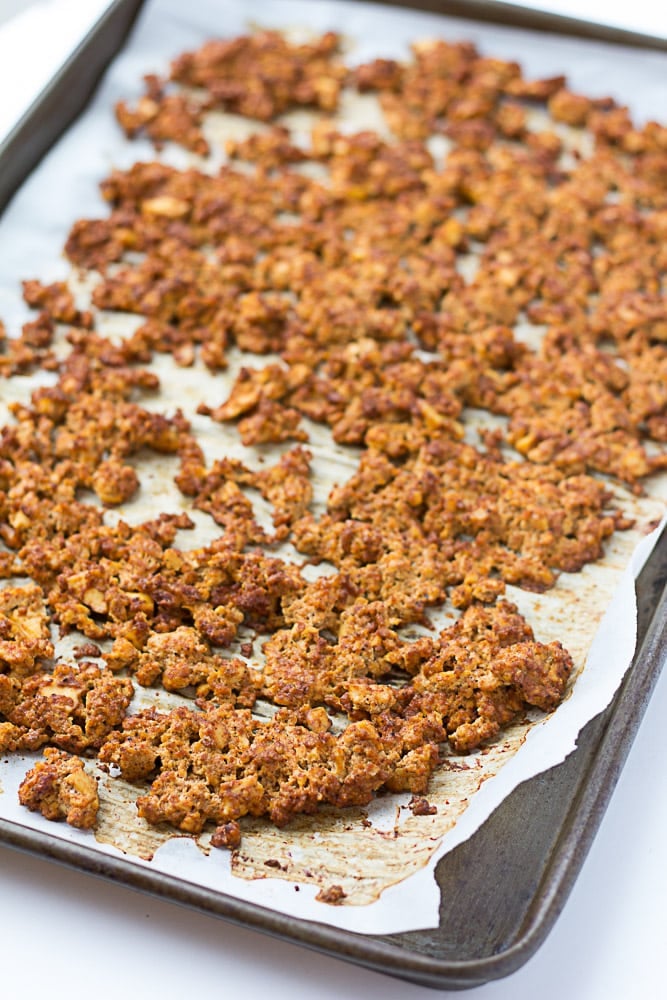 crumbled baked tofu on a parchment lined pan.