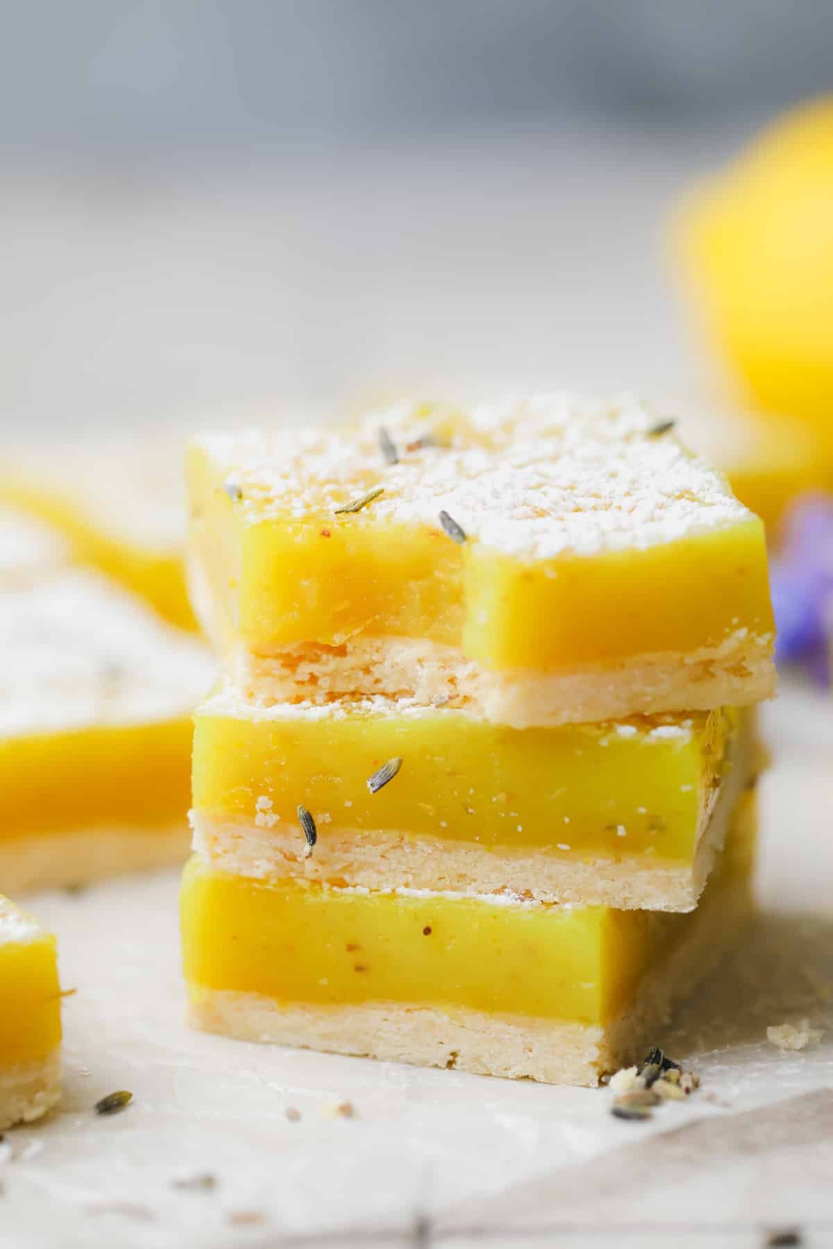 stack of 3 lavender lemon bars, grey background.