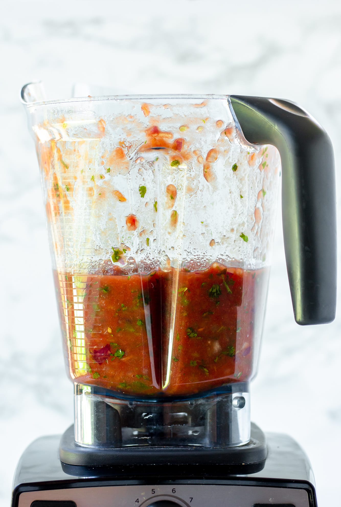 a batch of blended tomato salsa in a Vitamix blender.