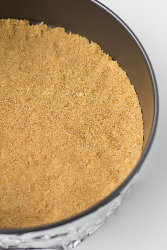 graham cracker crust in a springform pan not yet cooked