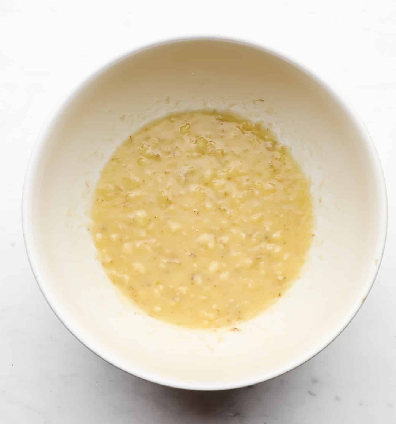 mashed bananas in a white bowl.