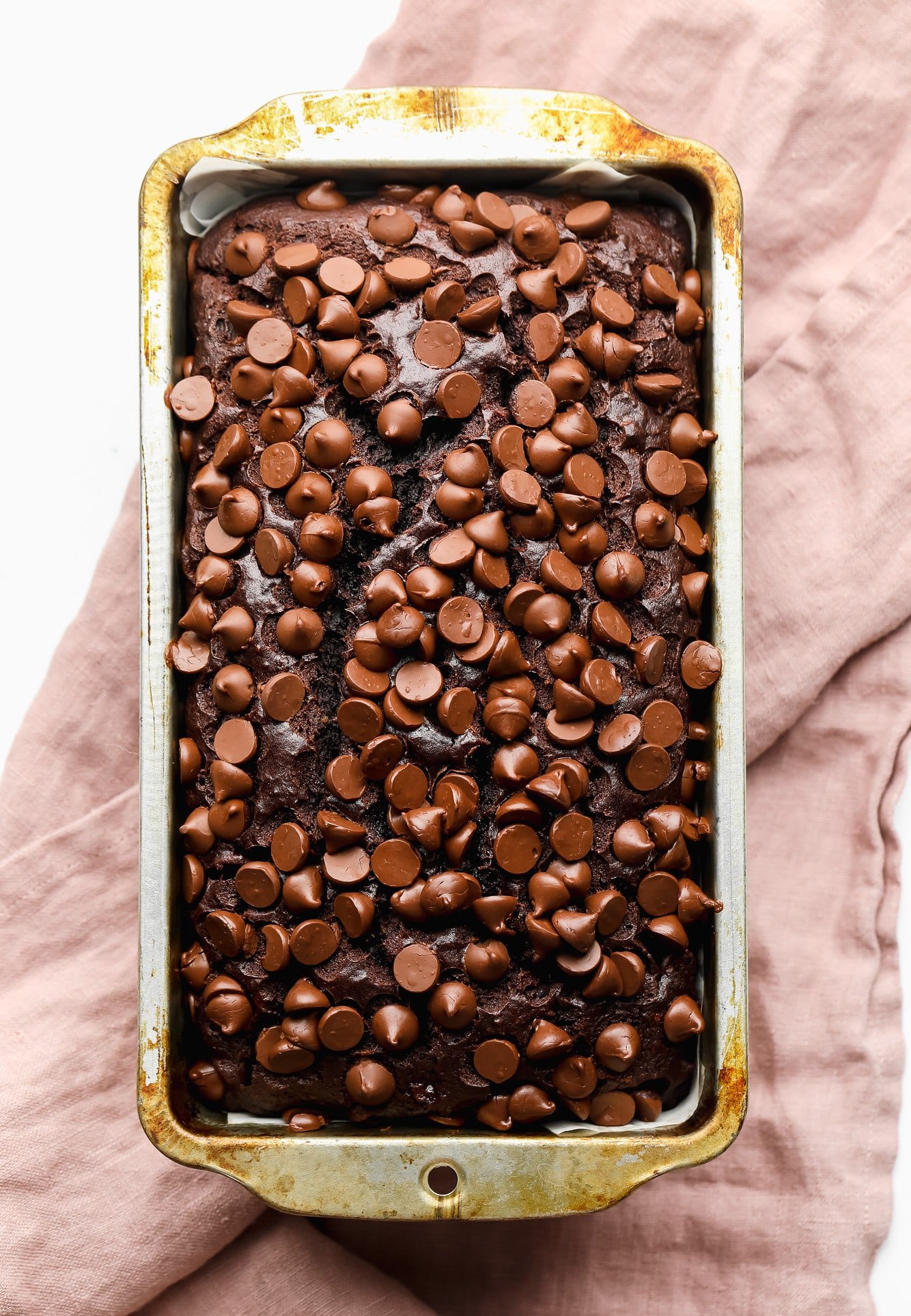 chocolate chip-topped chocolate banana bread in a loaf pan.