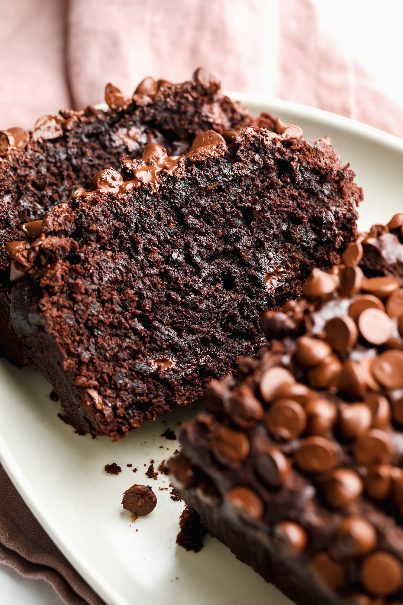 slices of chocolate banana bread on a white plate.