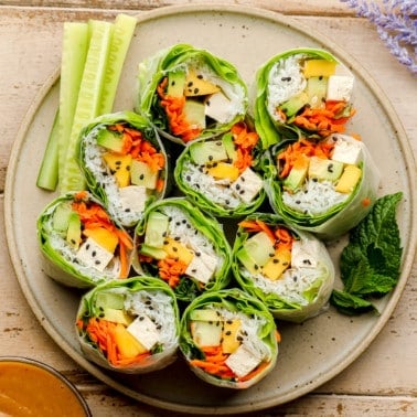 square image of fresh spring rolls on light brown plate