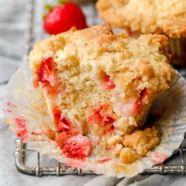 close up on a baked strawberry muffin that's been split in half.