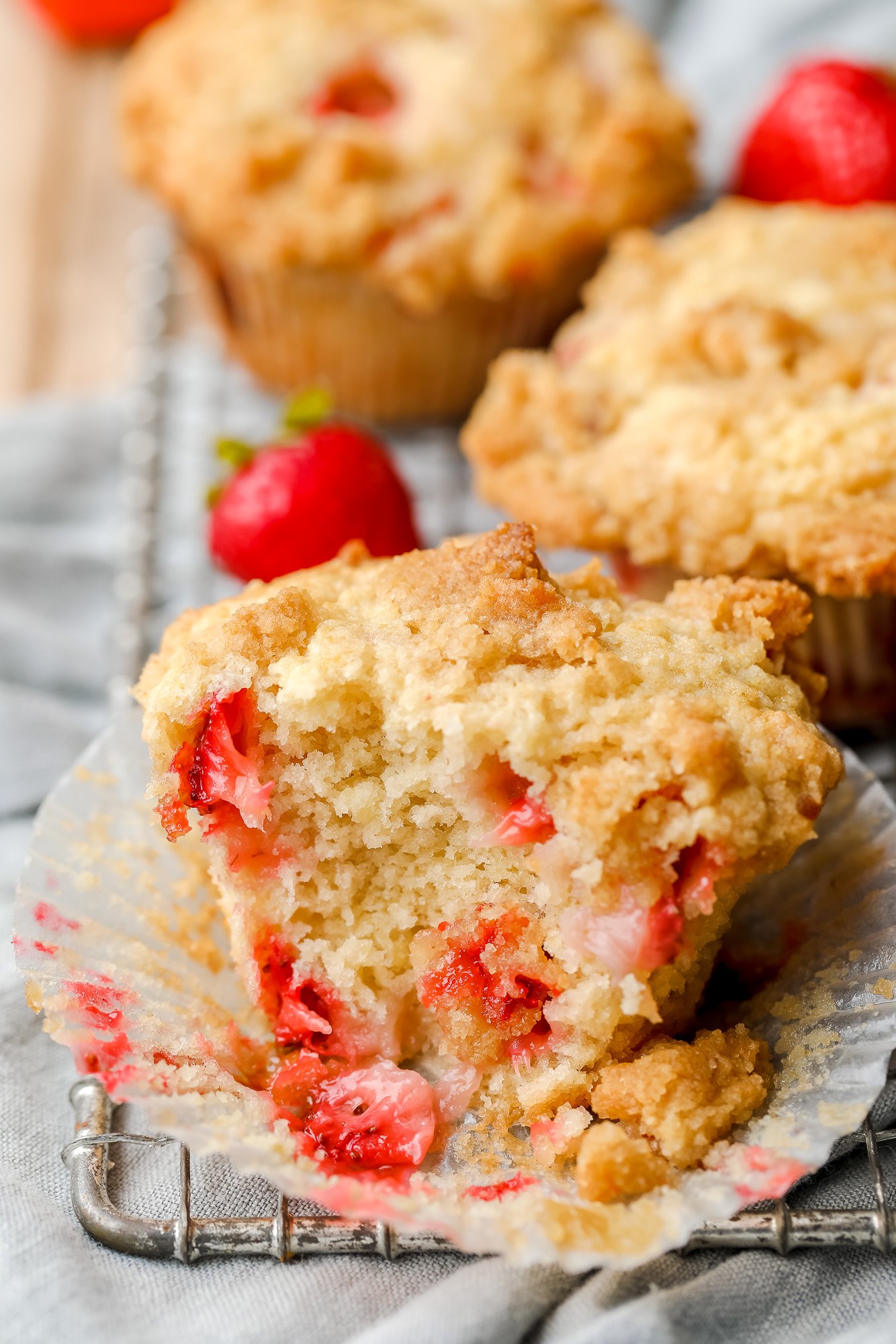 close up on a baked strawberry muffin that's been split in half.