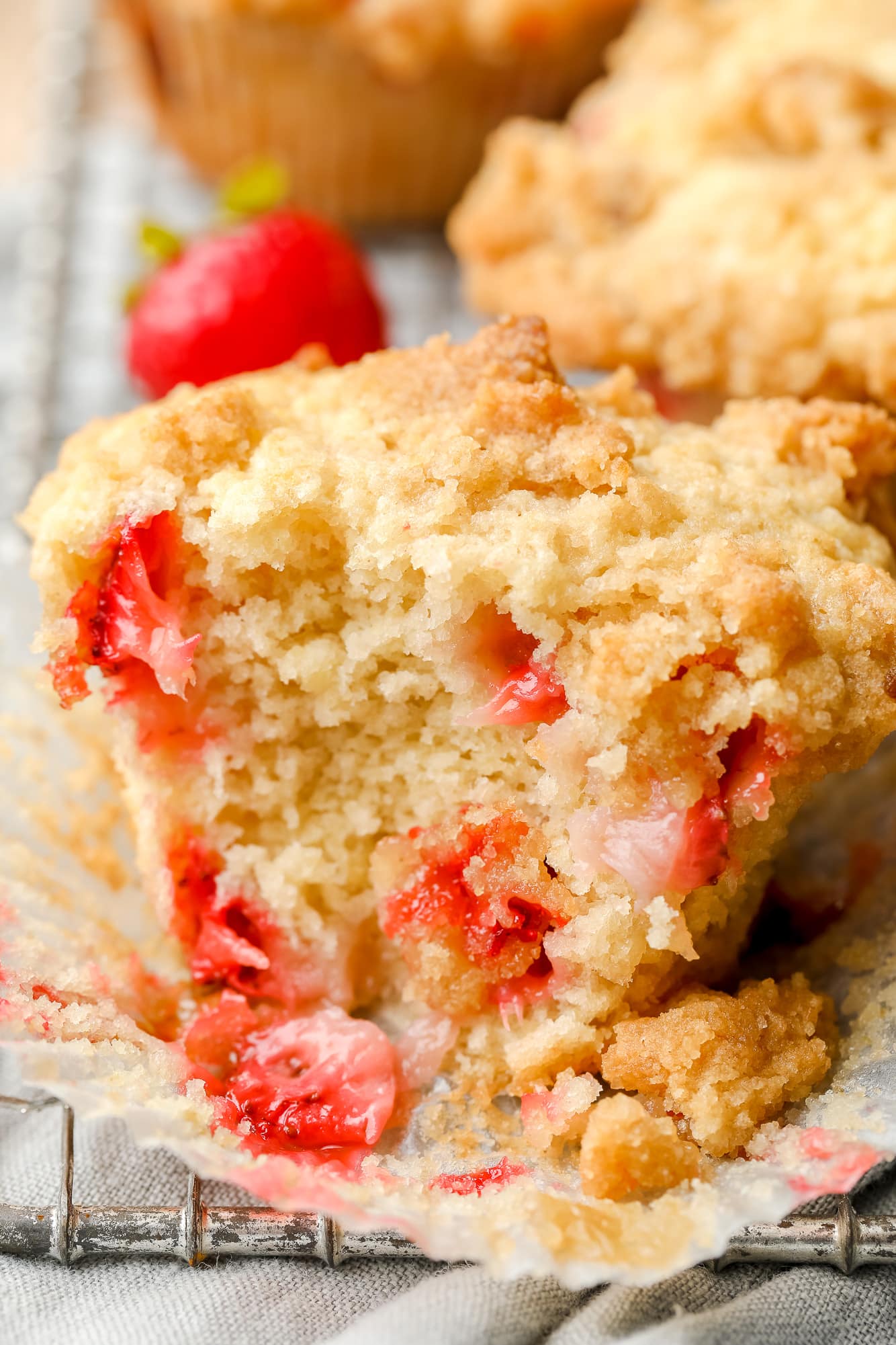 close up on a baked strawberry muffin that's been split in half.