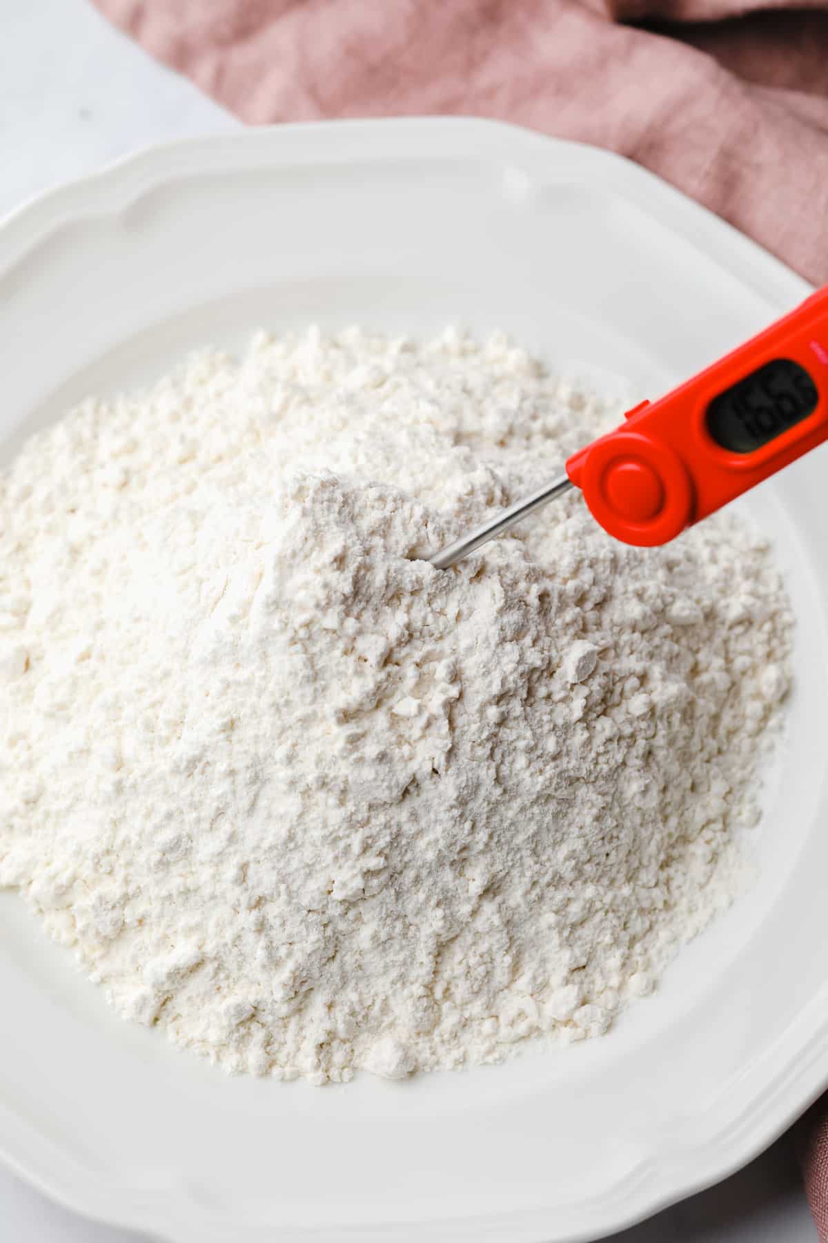 flour on a plate with a thermometer sticking in it