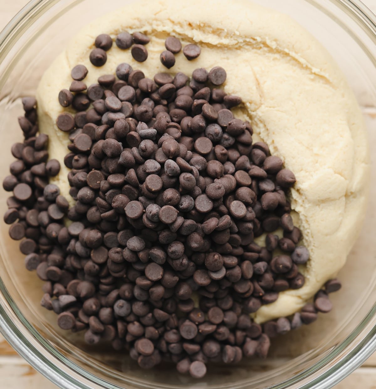 mini chocolate chips of top of what looks like golden dough