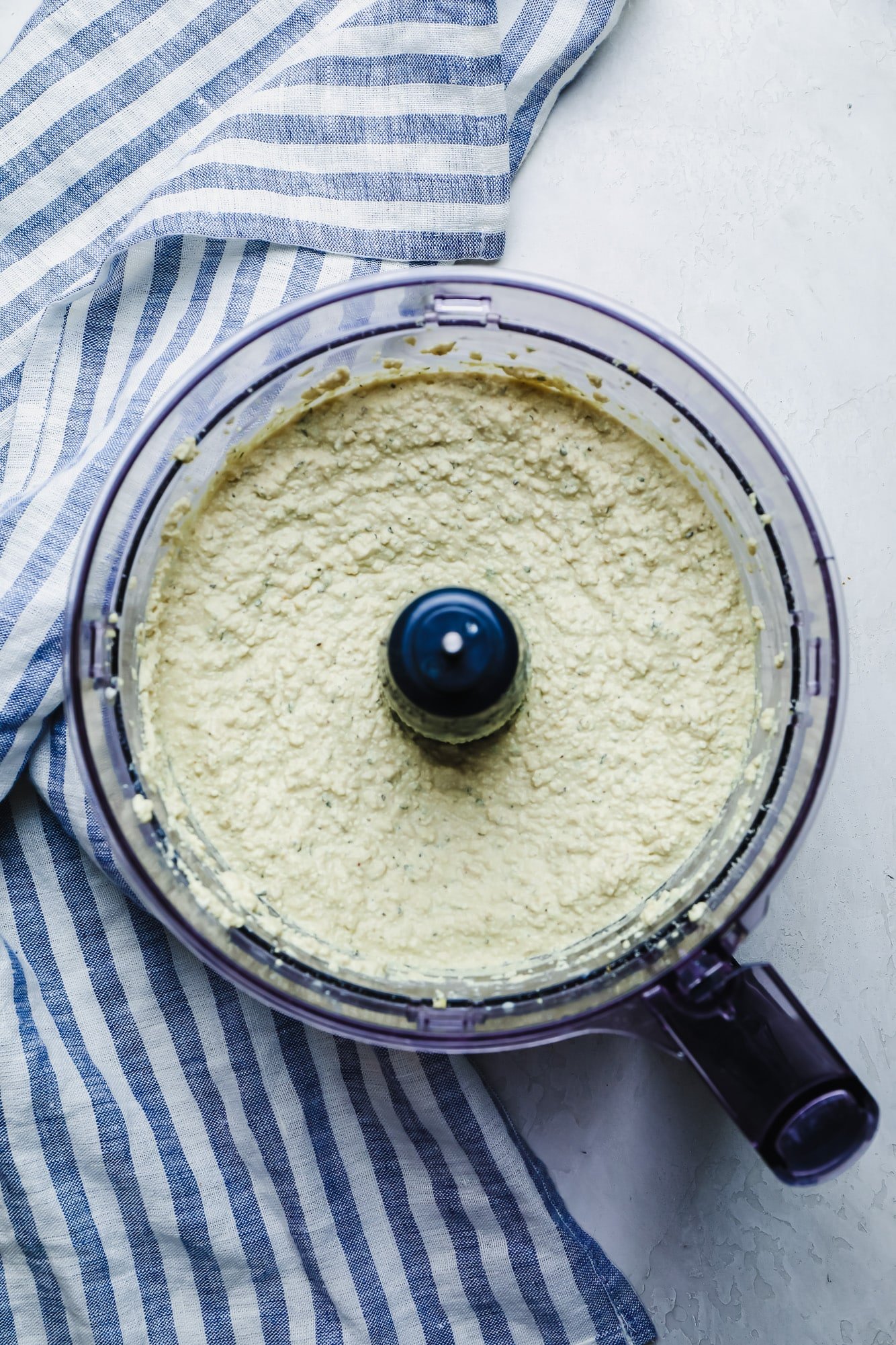 creamy white vegan cashew ricotta in a food processor.