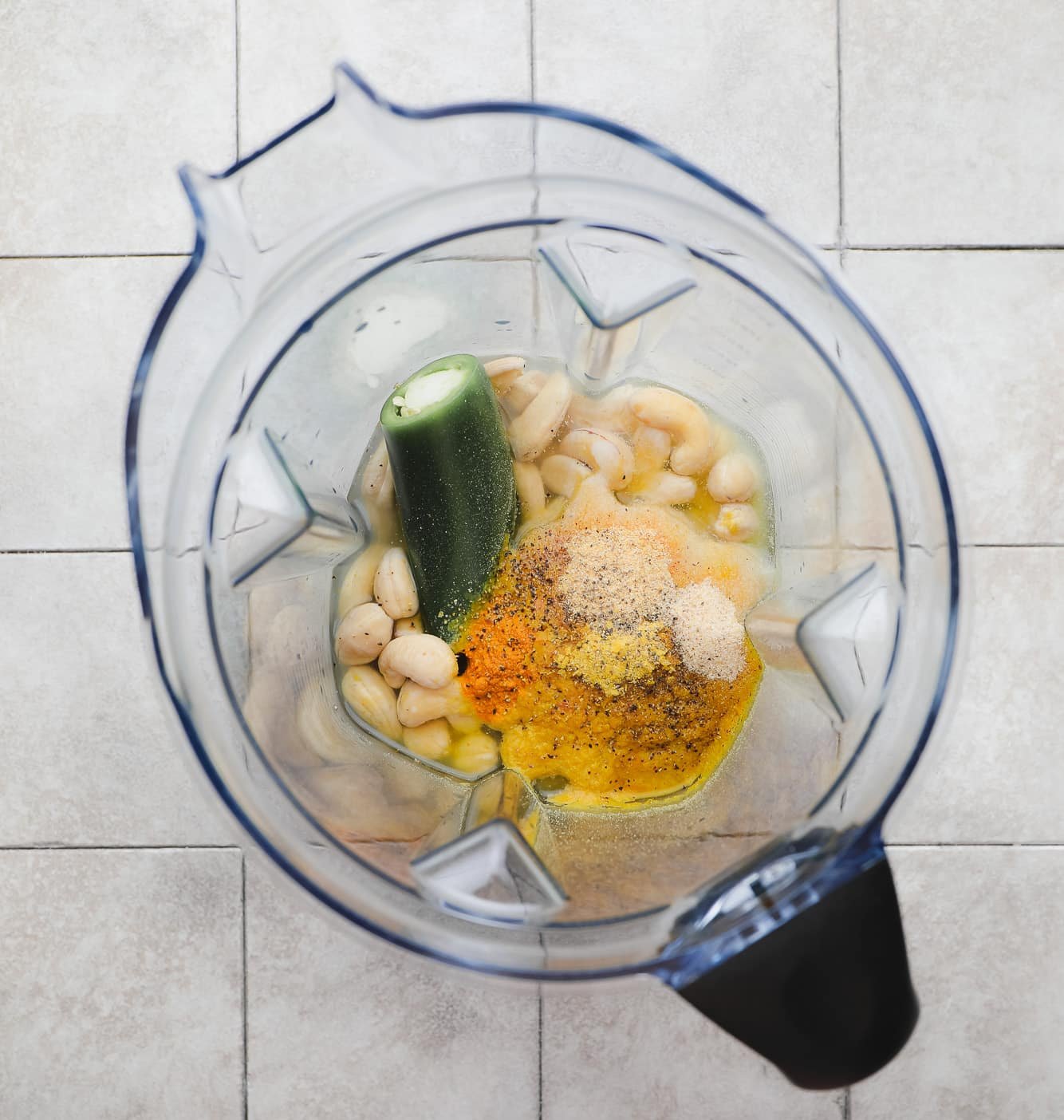 The ingredients for cashew cheese sauce in a large blender.