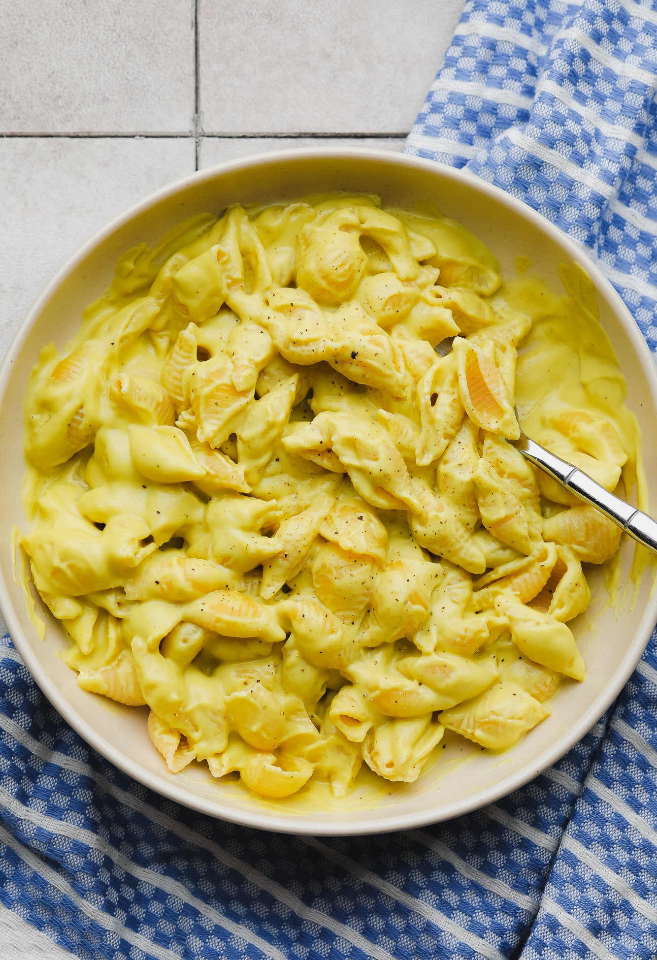 vegan mac and cheese in a beige bowl.