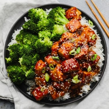 square image of lots of broccoli, teriyaki tofu on white rice