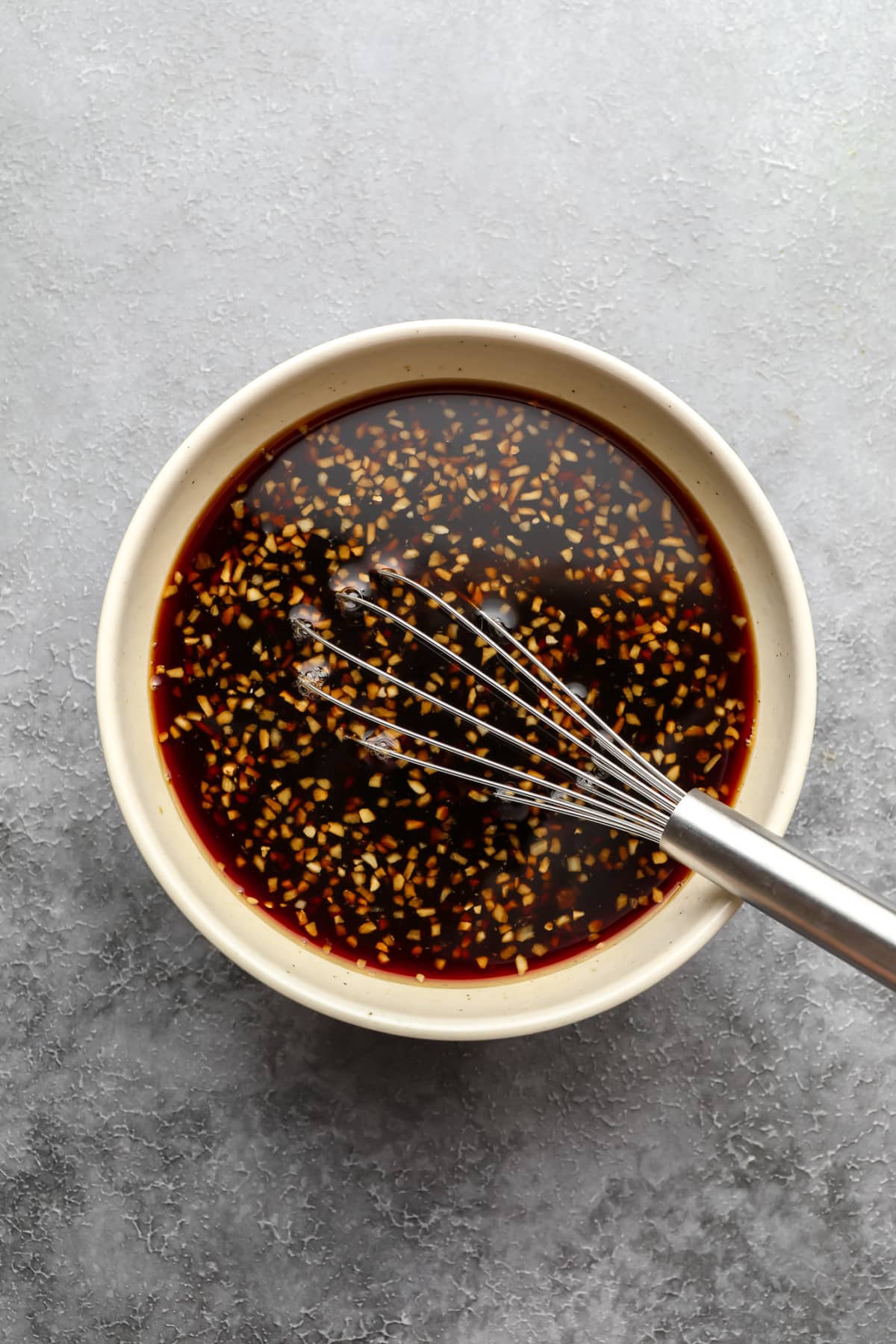 teriyaki sauce in white bowl on grey background