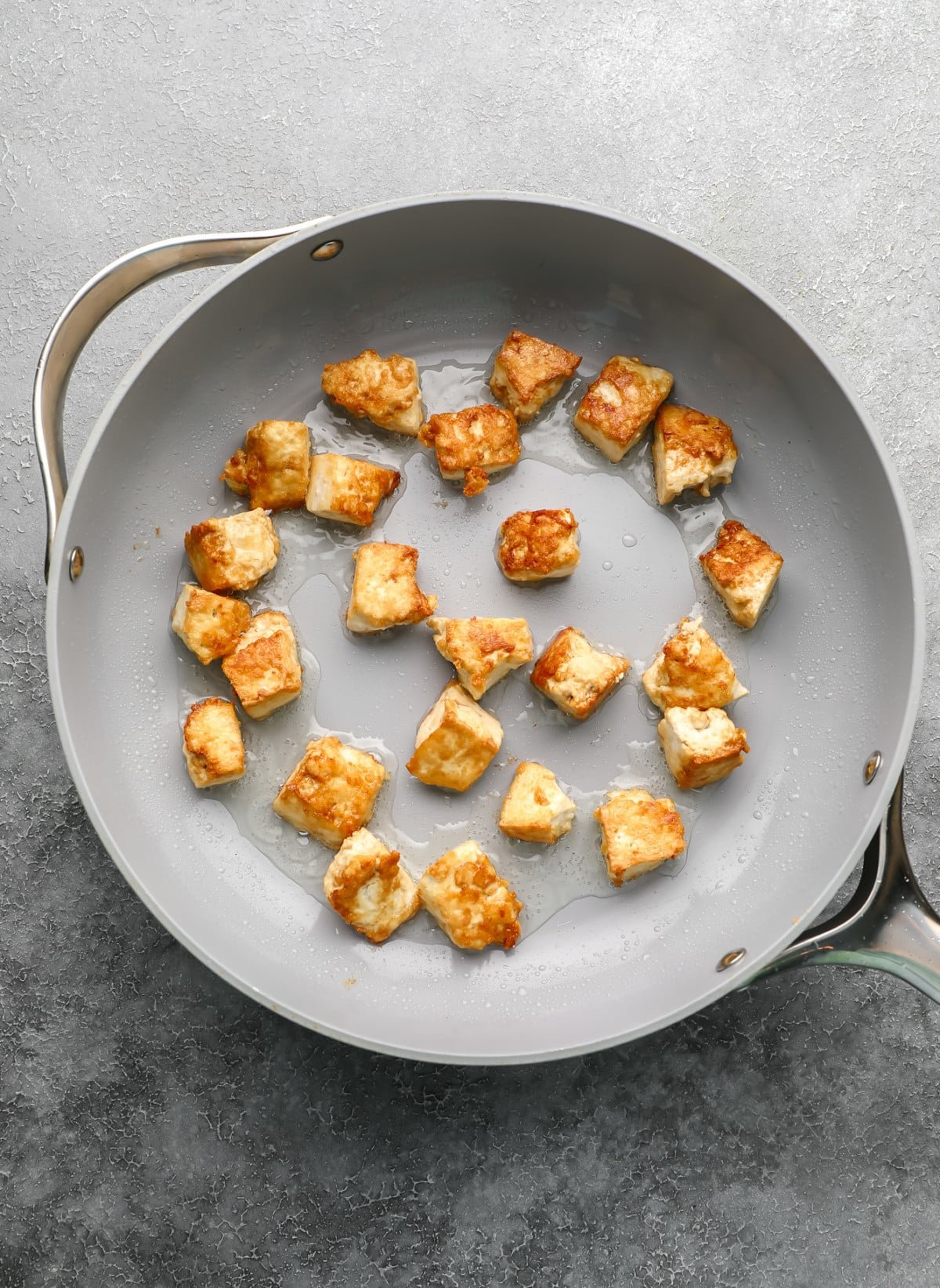 fried tofu in a grey pan