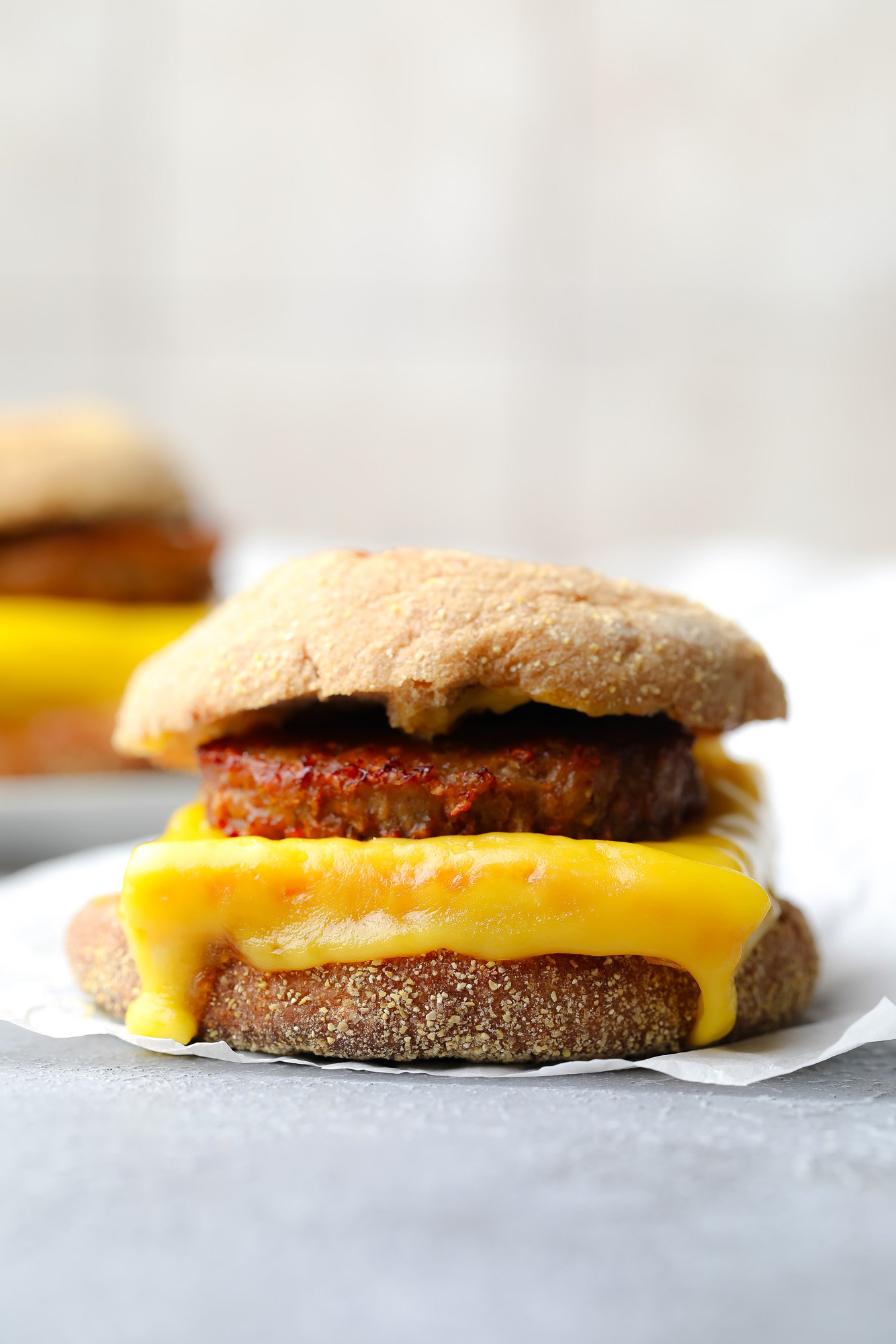 a vegan breakfast sandwich on a piece of parchment paper.