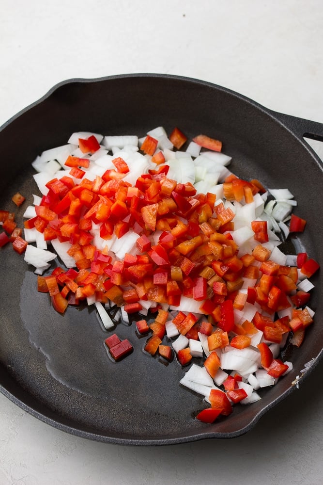 red peppers and onions in a pan uncooked