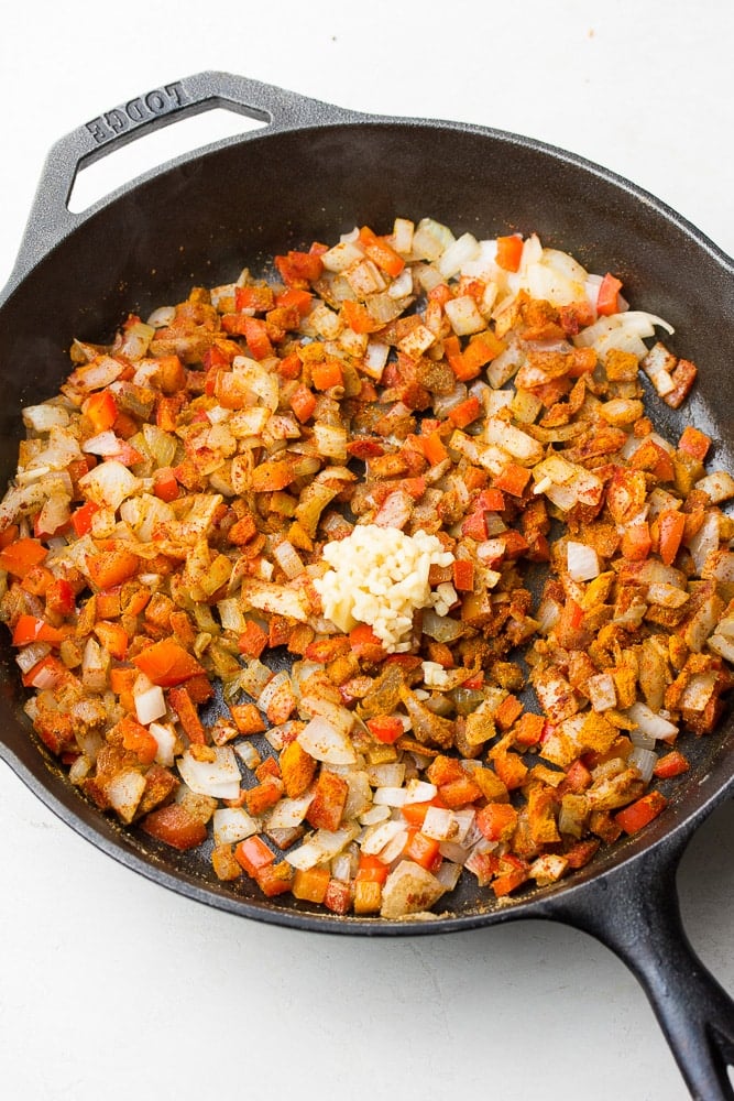 peppers and onions in a cast iron pan