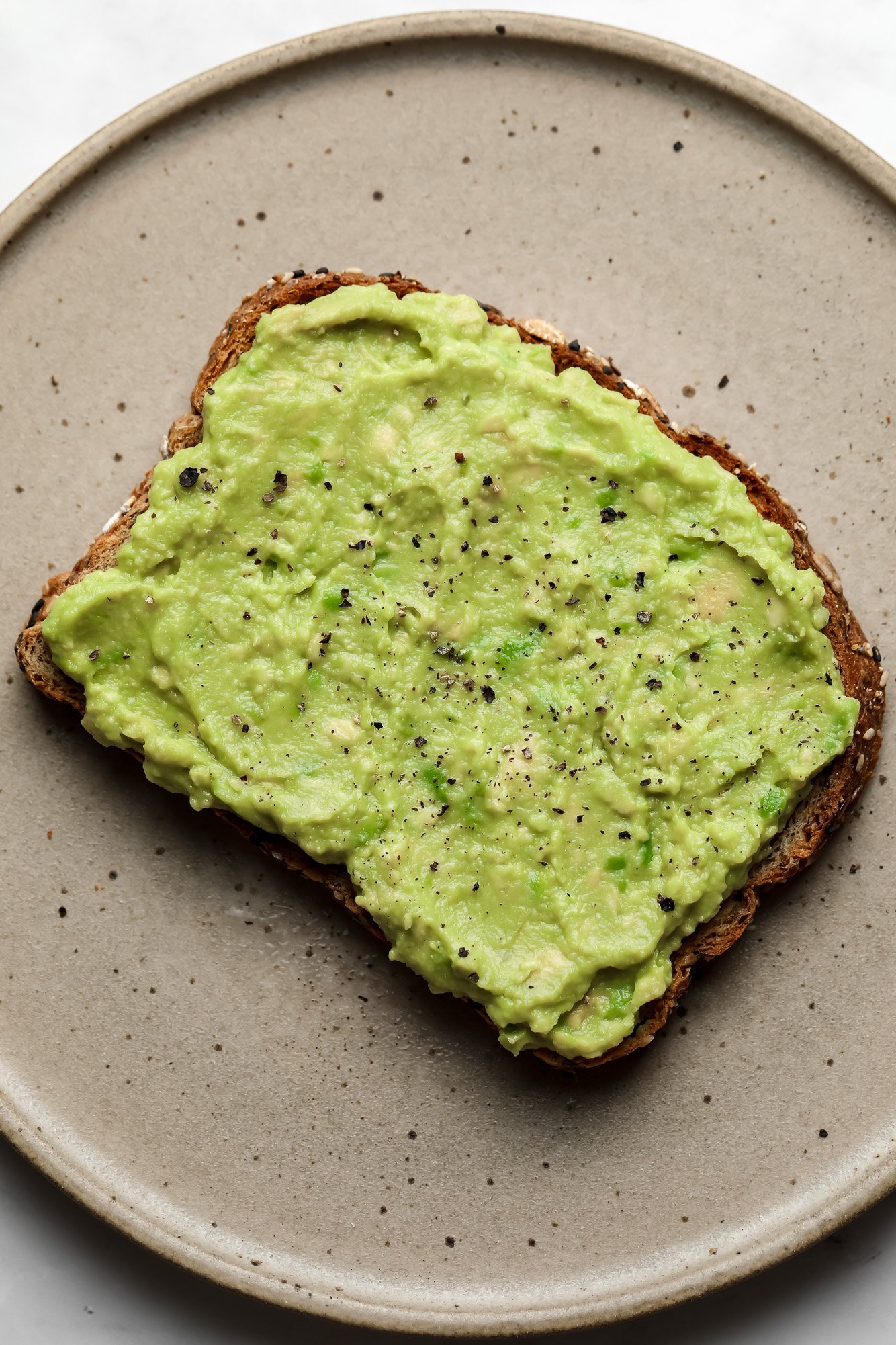 mashed avocado spread on a piece of toast.